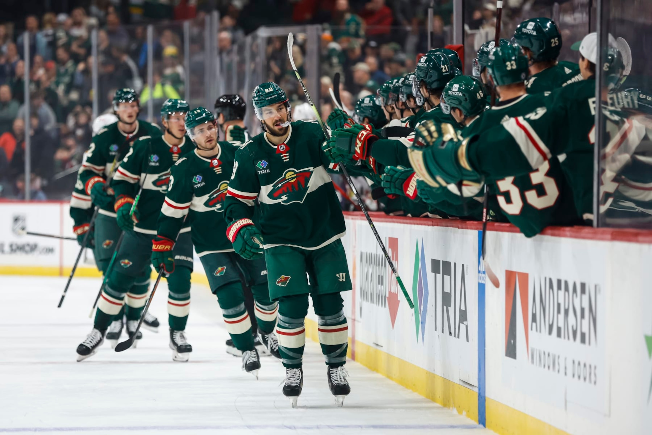 ST PAUL, MN - OCTOBER 06: Frederick Gaudreau #89 of the Minnesota Wild skates by the Wild bench to celebrate his goal with teammates against the Chicago Blackhawks with teammates in the first period of a preseason game at Xcel Energy Center on October 6, 2022 in St Paul, Minnesota. (Photo by David Berding/Getty Images)
