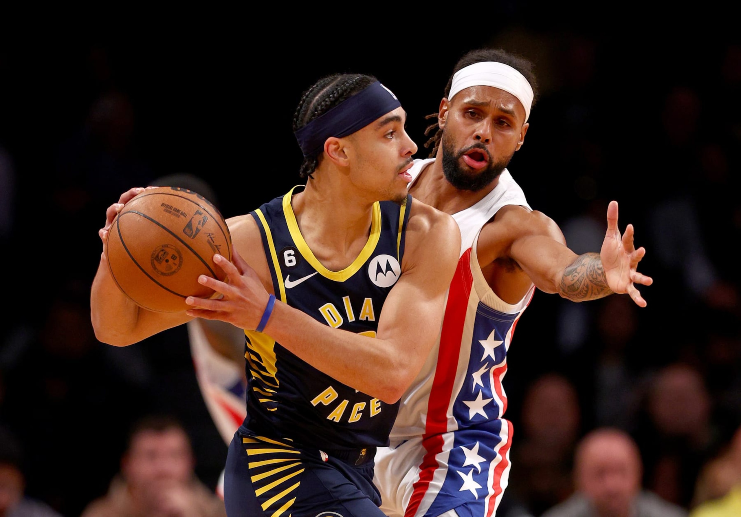 NEW YORK, NEW YORK - OCTOBER 29:  Andrew Nembhard #2 of the Indiana Pacers tries to keep the ball from Patty Mills #8 of the Brooklyn Nets in the first half at Barclays Center on October 29, 2022 in the Brooklyn borough of New York City. NOTE TO USER: User expressly acknowledges and agrees that, by downloading and or using this photograph, User is consenting to the terms and conditions of the Getty Images License Agreement. (Photo by Elsa/Getty Images)