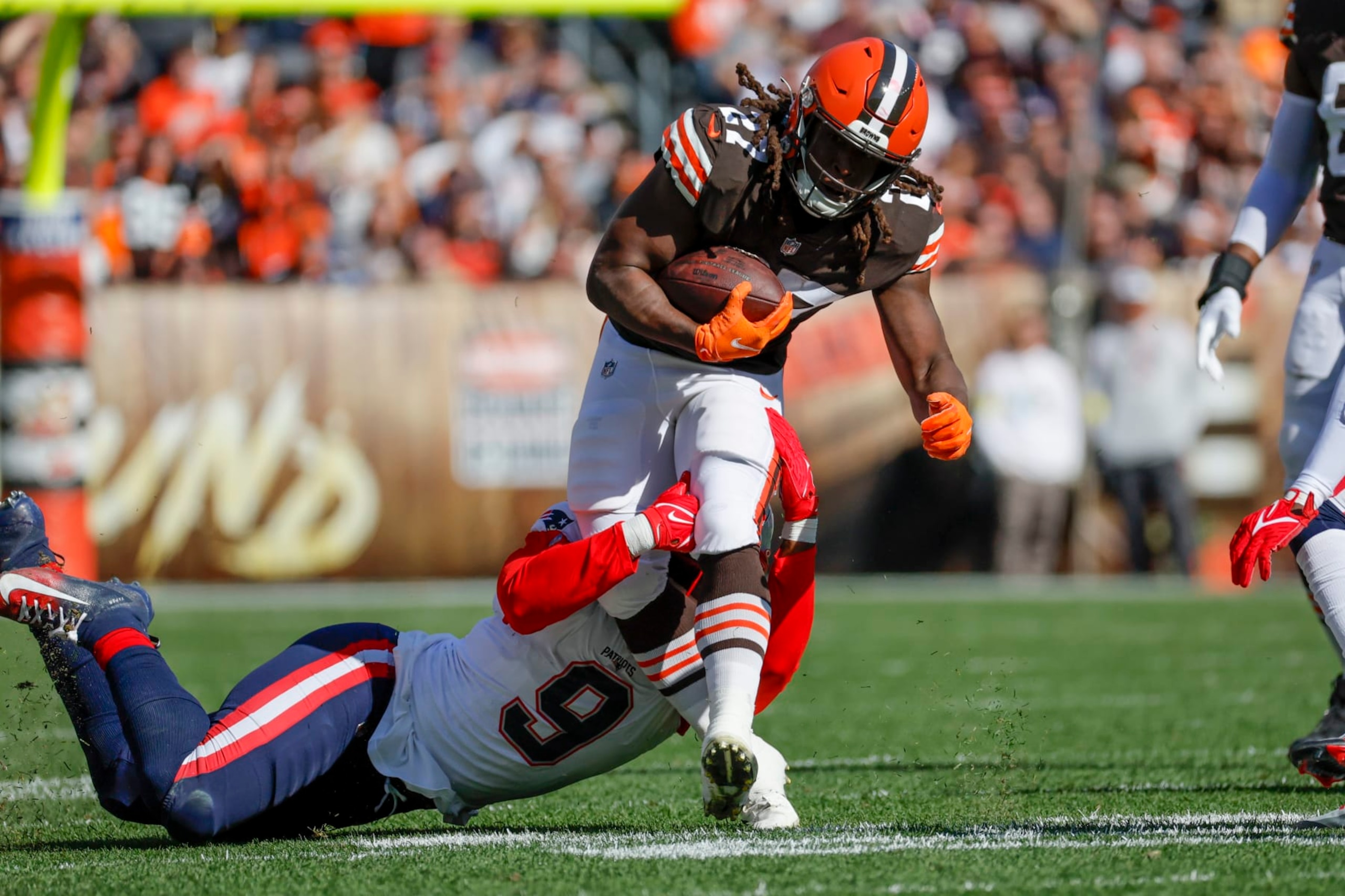 Cleveland Browns running back Kareem Hunt (27) is tackled by New England Patriots linebacker Matthew Judon (9) in the first half an NFL football game in Cleveland, Sunday, Oct. 16, 2022, (AP Photo/Rick Osentoski)
