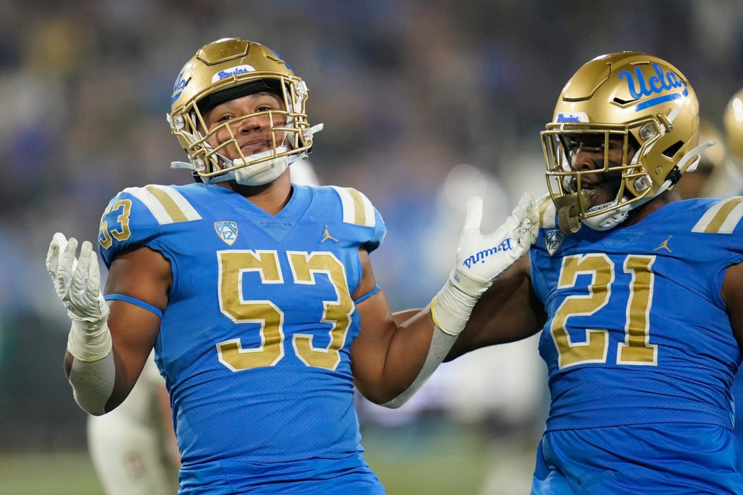 UCLA linebacker Darius Muasau (53) celebrates with linebacker JonJon Vaughns (21) after a stop during the second half of an NCAA college football game against Stanford in Pasadena, Calif., Saturday, Oct. 29, 2022. (AP Photo/Ashley Landis)