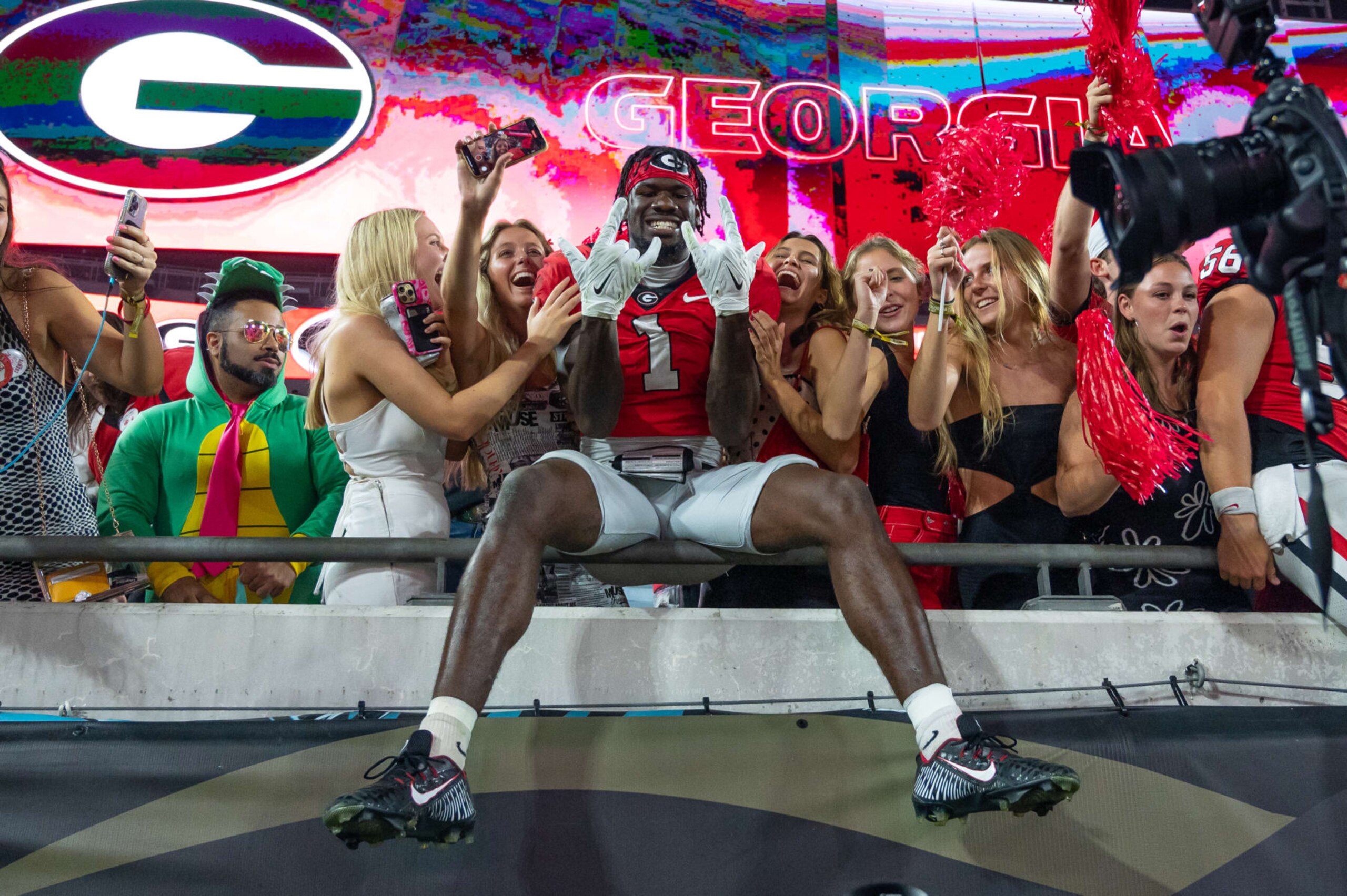 JACKSONVILLE, FL - OCTOBER 29: Georgia Bulldogs wide receiver Marcus Rosemy-Jacksaint (1) jumps in the stands with the Georgia Bulldogs faithful after the college football game between the Florida Gators and Georgia Bulldogs on October 29, 2022, at TIAA Bank Field in Jacksonville, Florida. (Photo by John Adams/Icon Sportswire via Getty Images)