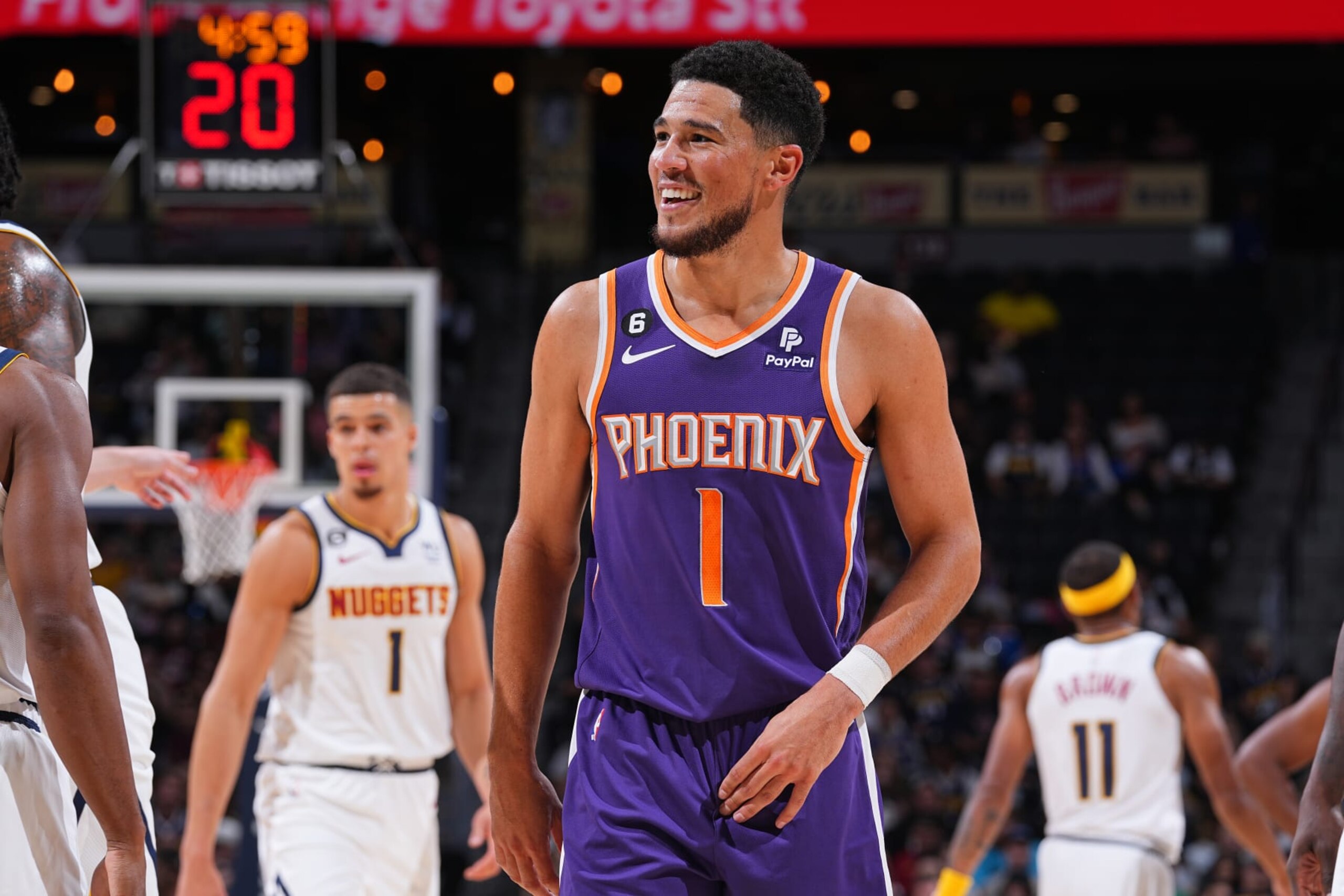 DENVER, CO - OCTOBER 10: Devin Booker #1 of the Phoenix Suns smiles and looks on during the game against the Denver Nuggets on October 10, 2022 at the Ball Arena in Denver, Colorado. NOTE TO USER: User expressly acknowledges and agrees that, by downloading and/or using this Photograph, user is consenting to the terms and conditions of the Getty Images License Agreement. Mandatory Copyright Notice: Copyright 2022 NBAE (Photo by Bart Young/NBAE via Getty Images)