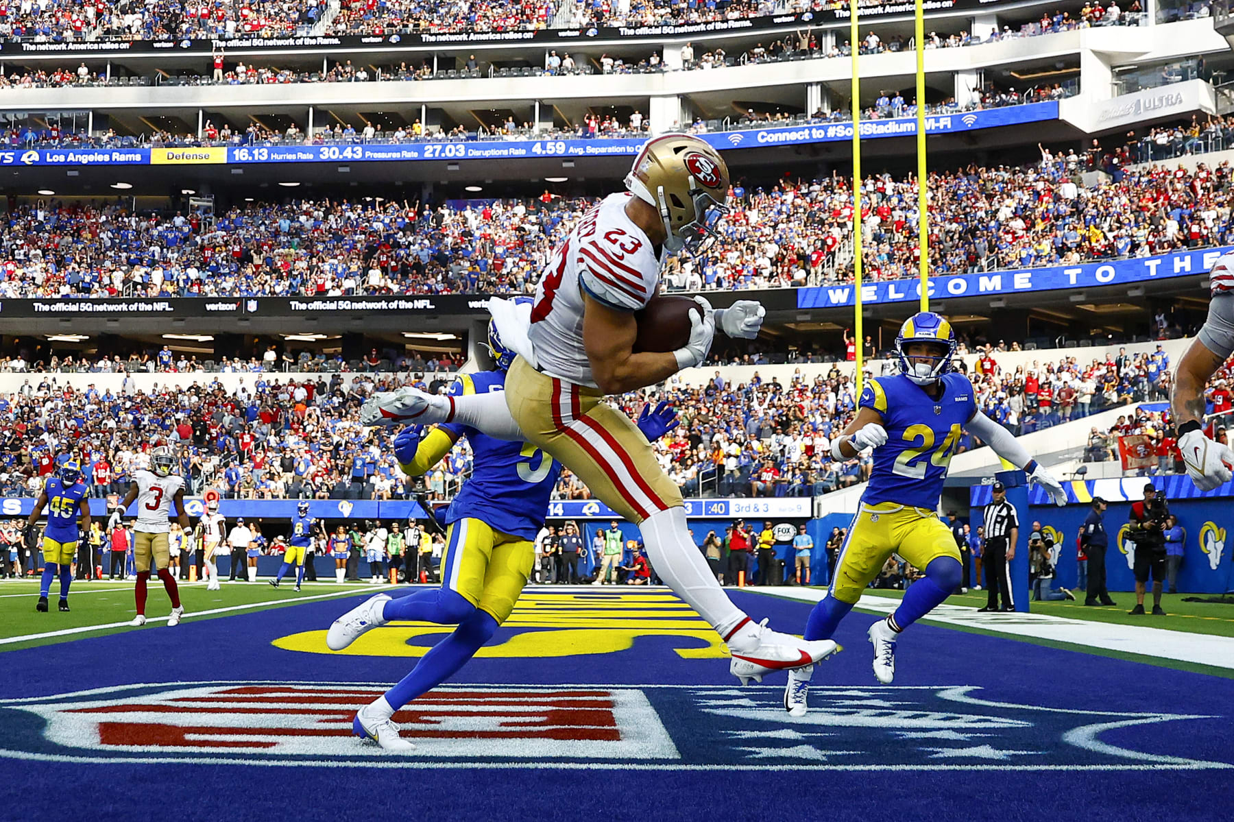 INGLEWOOD, CALIFORNIA - OCTOBER 30: Christian McCaffrey #23 of the San Francisco 49ers catches the ball for a touchdown as Jalen Ramsey #5 and Taylor Rapp #24 of the Los Angeles Rams defend during the third quarter at SoFi Stadium on October 30, 2022 in Inglewood, California. (Photo by Ronald Martinez/Getty Images)