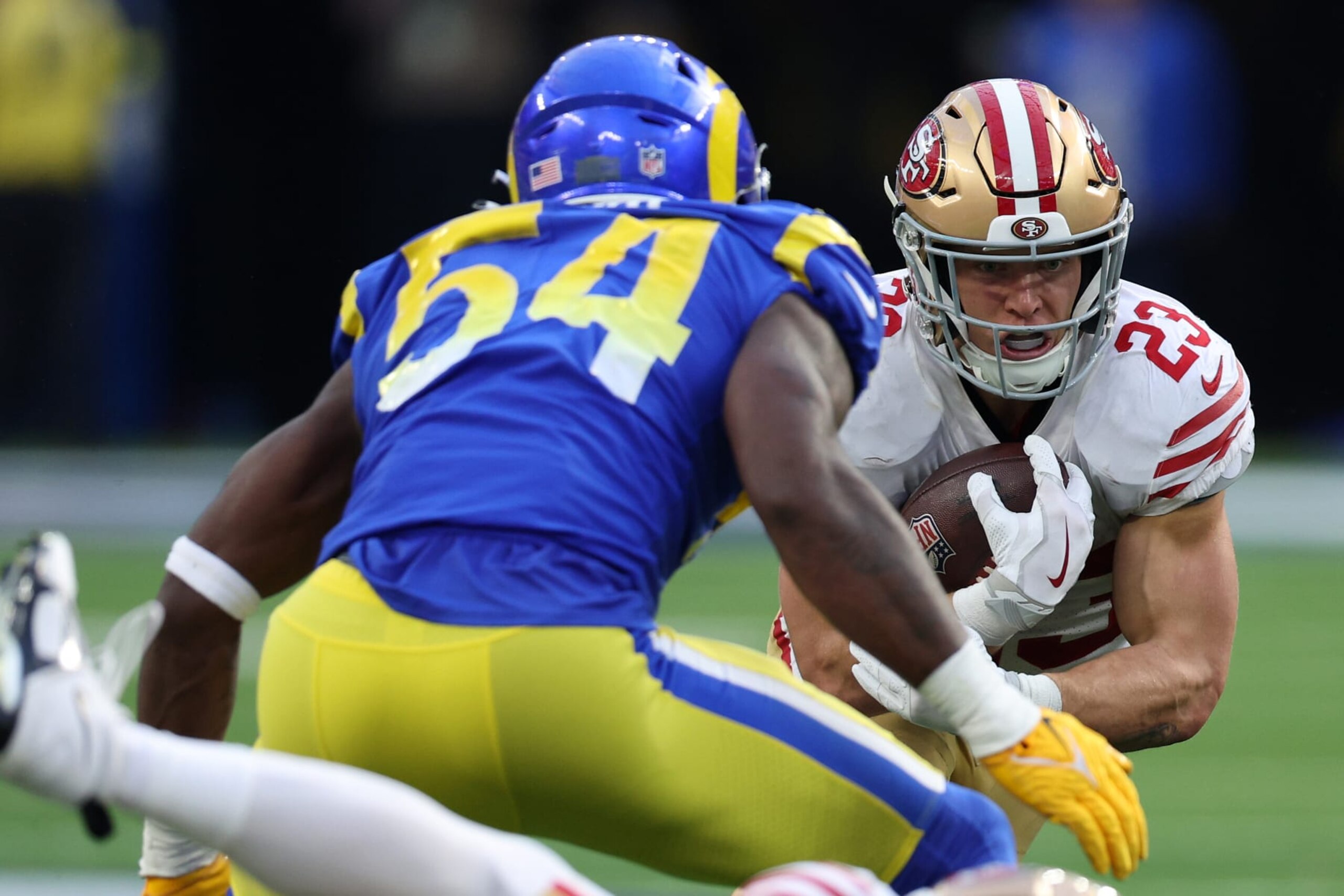 INGLEWOOD, CALIFORNIA - OCTOBER 30: Christian McCaffrey #23 of the San Francisco 49ers runs with the ball as Leonard Floyd #54 of the Los Angeles Rams defends during the fourth quarter at SoFi Stadium on October 30, 2022 in Inglewood, California. (Photo by Harry How/Getty Images) INGLEWOOD, CALIFORNIA - OCTOBER 30: Christian McCaffrey #23 of the San Francisco 49ers runs with the ball as Leonard Floyd #54 of the Los Angeles Rams defends during the fourth quarter at SoFi Stadium on October 30, 2022 in Inglewood, California. (Photo by Harry How/Getty Images)