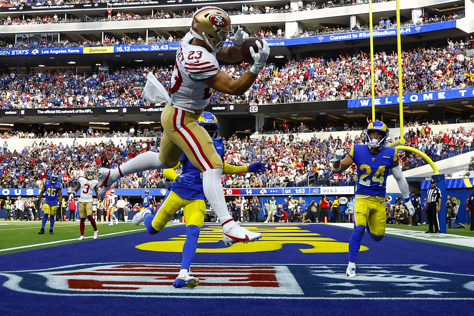 INGLEWOOD, CALIFORNIA - OCTOBER 30: Christian McCaffrey #23 of the San Francisco 49ers catches the ball for a touchdown as Jalen Ramsey #5 and Taylor Rapp #24 of the Los Angeles Rams defend during the third quarter at SoFi Stadium on October 30, 2022 in Inglewood, California. (Photo by Ronald Martinez/Getty Images)