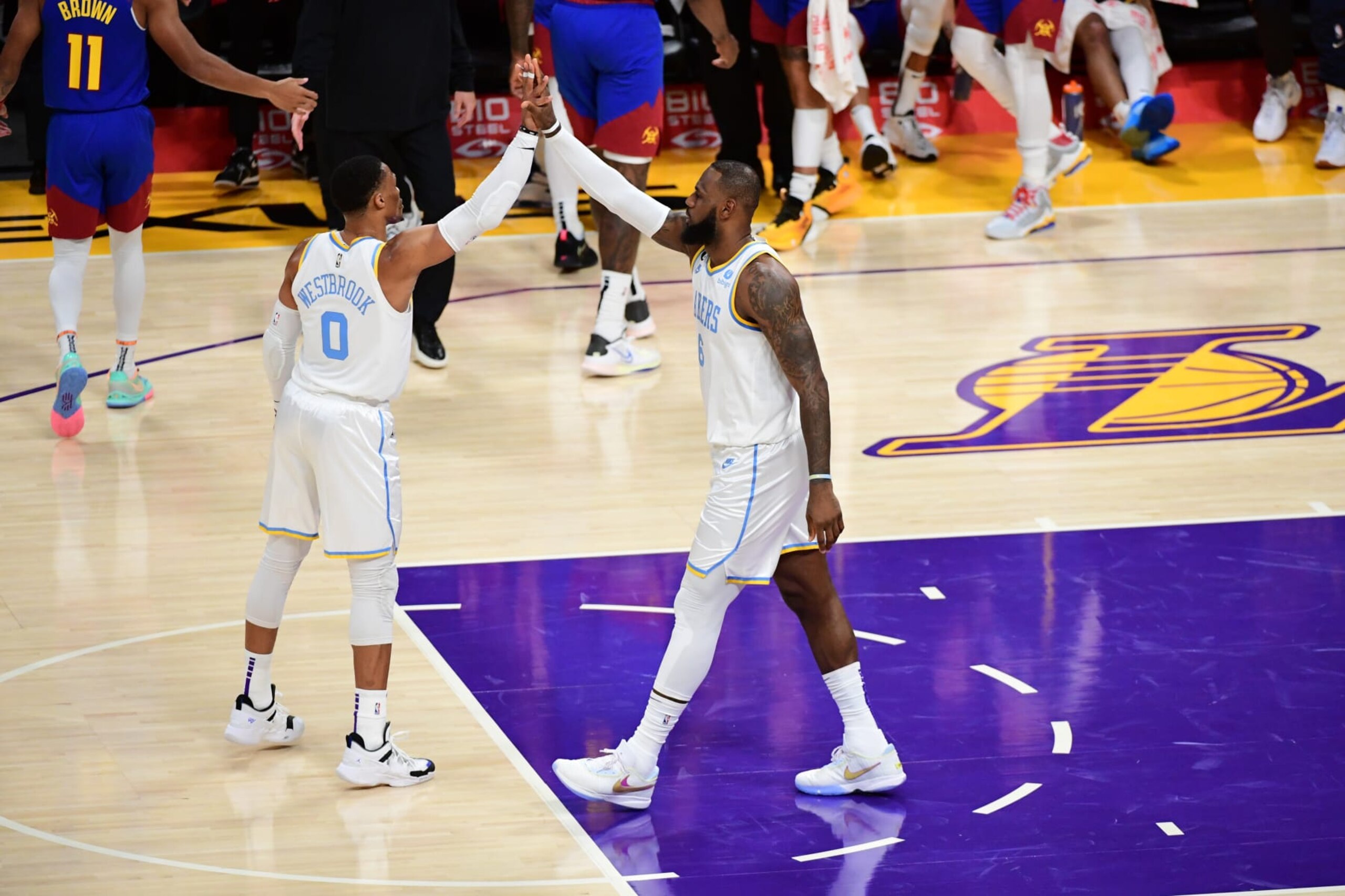 LOS ANGELES, CA - OCTOBER 30: Russell Westbrook #0 and LeBron James #6 of the Los Angeles Lakers high five during the game against the Denver Nuggets on October 30, 2022 at Crypto.Com Arena in Los Angeles, California. NOTE TO USER: User expressly acknowledges and agrees that, by downloading and/or using this Photograph, user is consenting to the terms and conditions of the Getty Images License Agreement. Mandatory Copyright Notice: Copyright 2022 NBAE (Photo by Adam Pantozzi/NBAE via Getty Images)