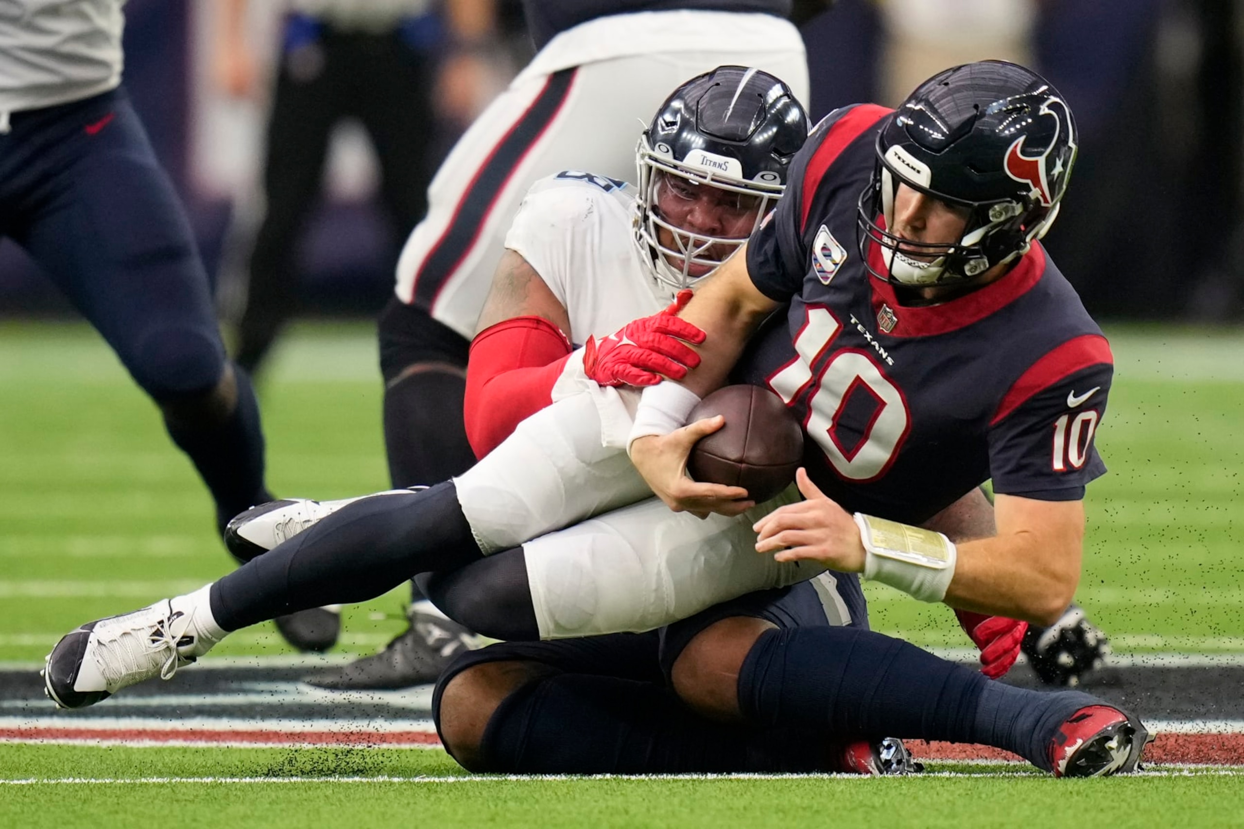 Tennessee Titans defensive tackle Jeffery Simmons sacks Houston Texans quarterback Davis Mills (10) for a 12-yard loss during the second half of an NFL football game Sunday, Oct. 30, 2022, in Houston. (AP Photo/Eric Christian Smith)