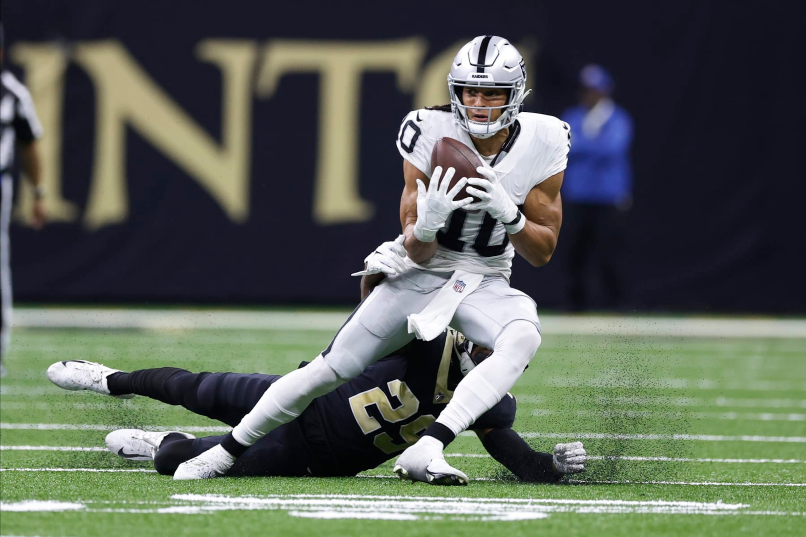 Las Vegas Raiders wide receiver Mack Hollins (10) makes a catch against New Orleans Saints cornerback Paulson Adebo (29) during the second half of an NFL football game Sunday, Oct. 30, 2022, in New Orleans. (AP Photo/Rusty Costanza)