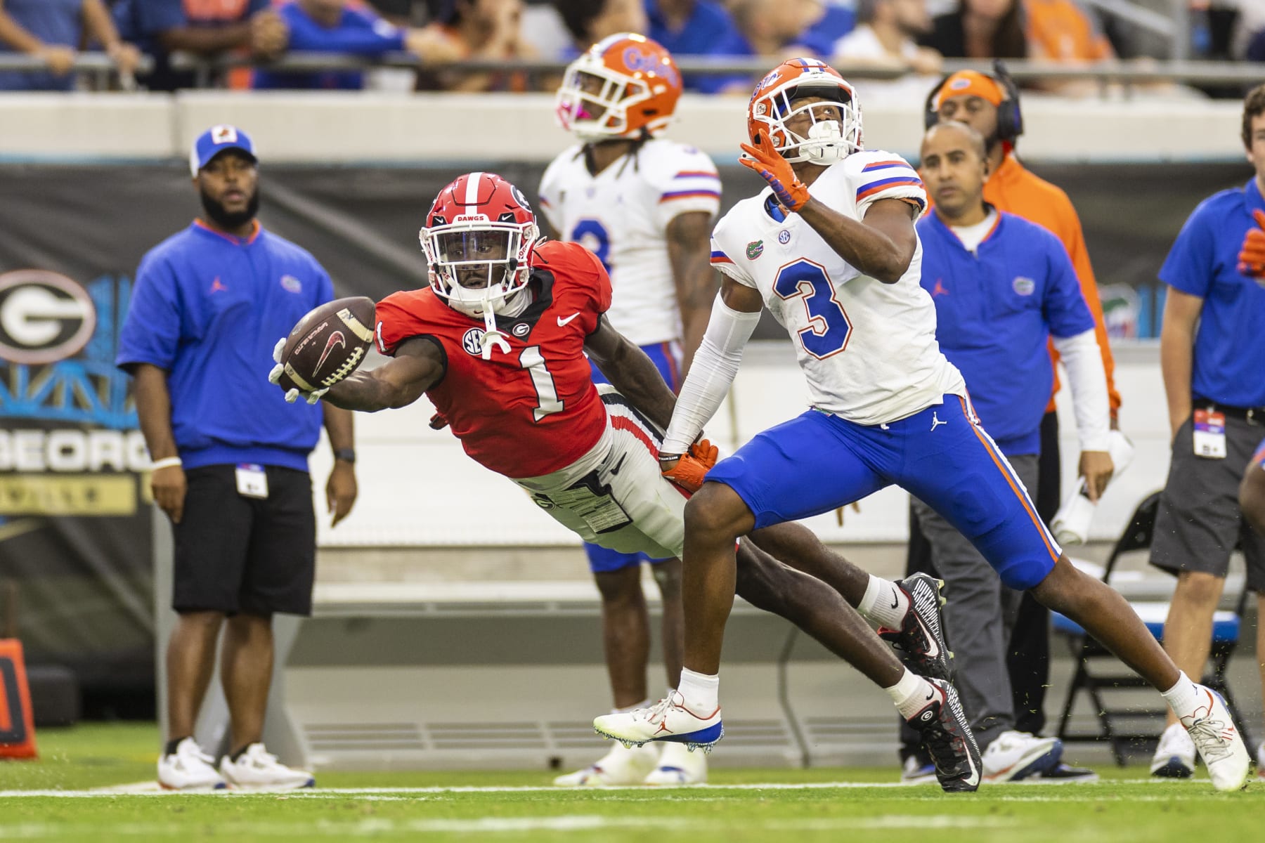 JACKSONVILLE, FLORIDA - OCTOBER 29: Marcus Rosemy-Jacksaint #1 of the Georgia Bulldogs attempts to catch a pass during the first half of a game against Jason Marshall Jr. #3 of the Florida Gators at TIAA Bank Field on October 29, 2022 in Jacksonville, Florida. (Photo by James Gilbert/Getty Images)