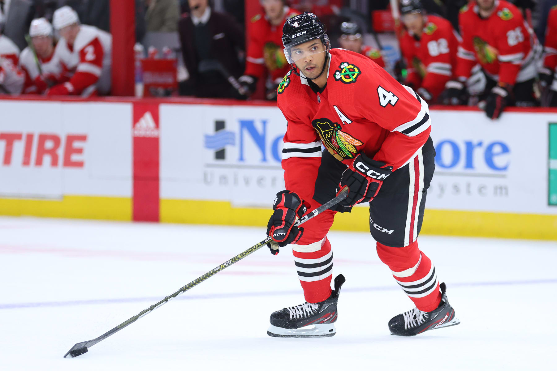 CHICAGO, ILLINOIS - OCTOBER 21: Seth Jones #4 of the Chicago Blackhawks skates with the puck against the Detroit Red Wings during overtime at United Center on October 21, 2022 in Chicago, Illinois. (Photo by Michael Reaves/Getty Images)
