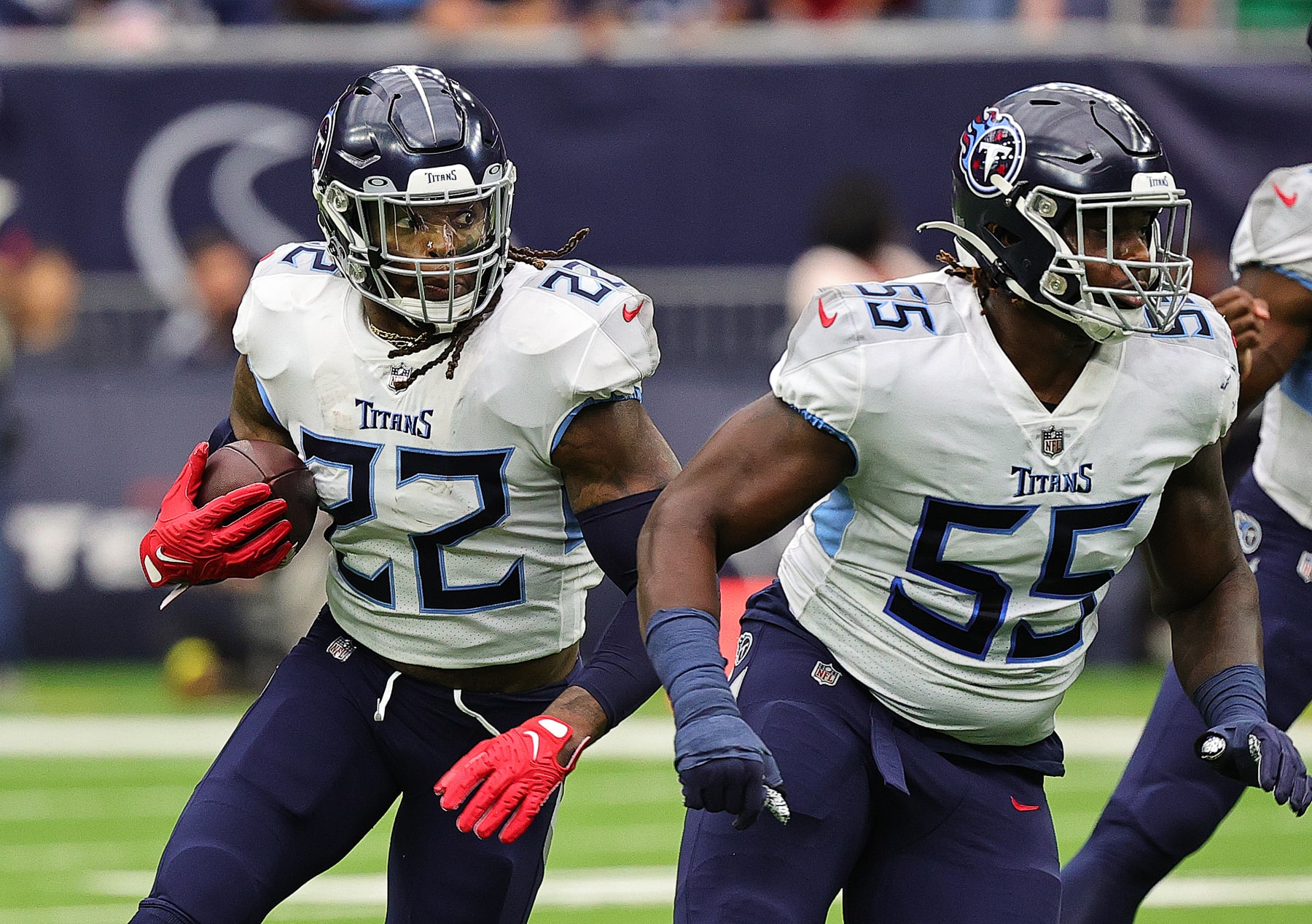 HOUSTON, TEXAS - OCTOBER 30: Derrick Henry #22 of the Tennessee Titans runs the ball as he gets a block from Aaron Brewer #55 against the Houston Texans at NRG Stadium on October 30, 2022 in Houston, Texas. The Tennessee Titans defeated the Houston Texans 17-10. (Photo by Bob Levey/Getty Images)