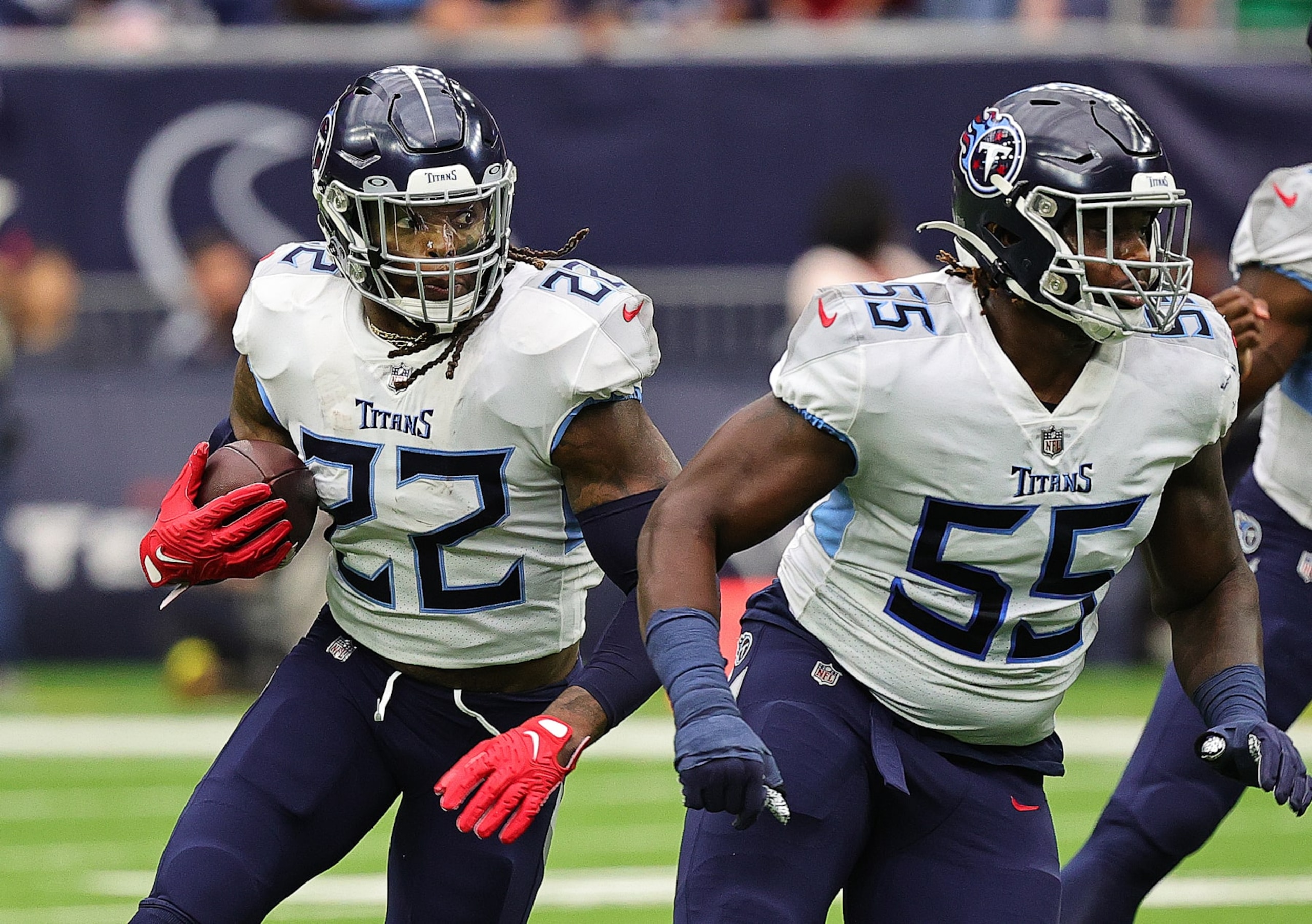 HOUSTON, TEXAS - OCTOBER 30: Derrick Henry #22 of the Tennessee Titans runs the ball as he gets a block from Aaron Brewer #55 against the Houston Texans at NRG Stadium on October 30, 2022 in Houston, Texas. The Tennessee Titans defeated the Houston Texans 17-10. (Photo by Bob Levey/Getty Images)