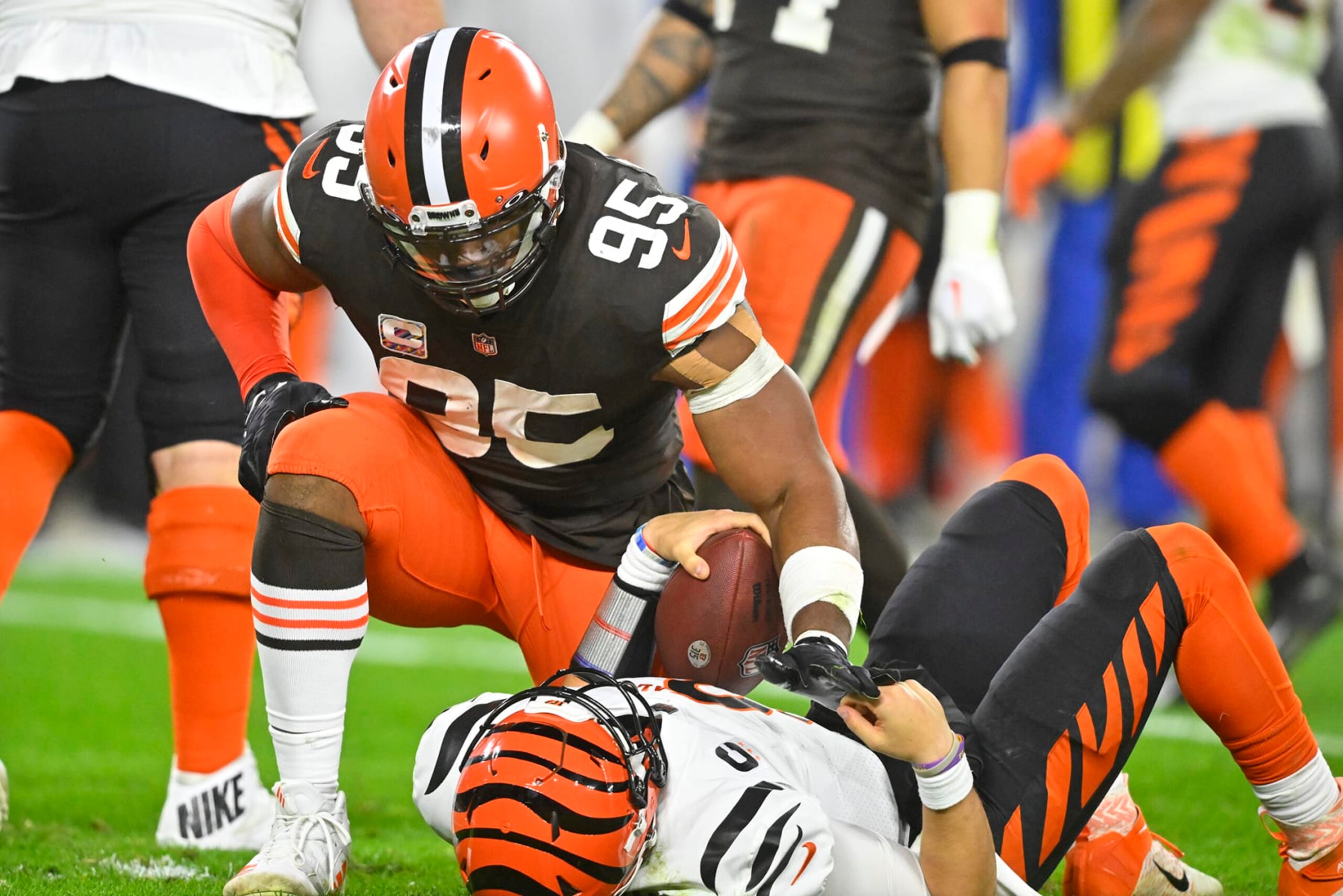 Cleveland Browns defensive end Myles Garrett (95) kneels over Cincinnati Bengals quarterback Joe Burrow (9) after sacking hime during the second half of an NFL football game in Cleveland, Monday, Oct. 31, 2022. The Browns won 32-13. (AP Photo/David Richard)