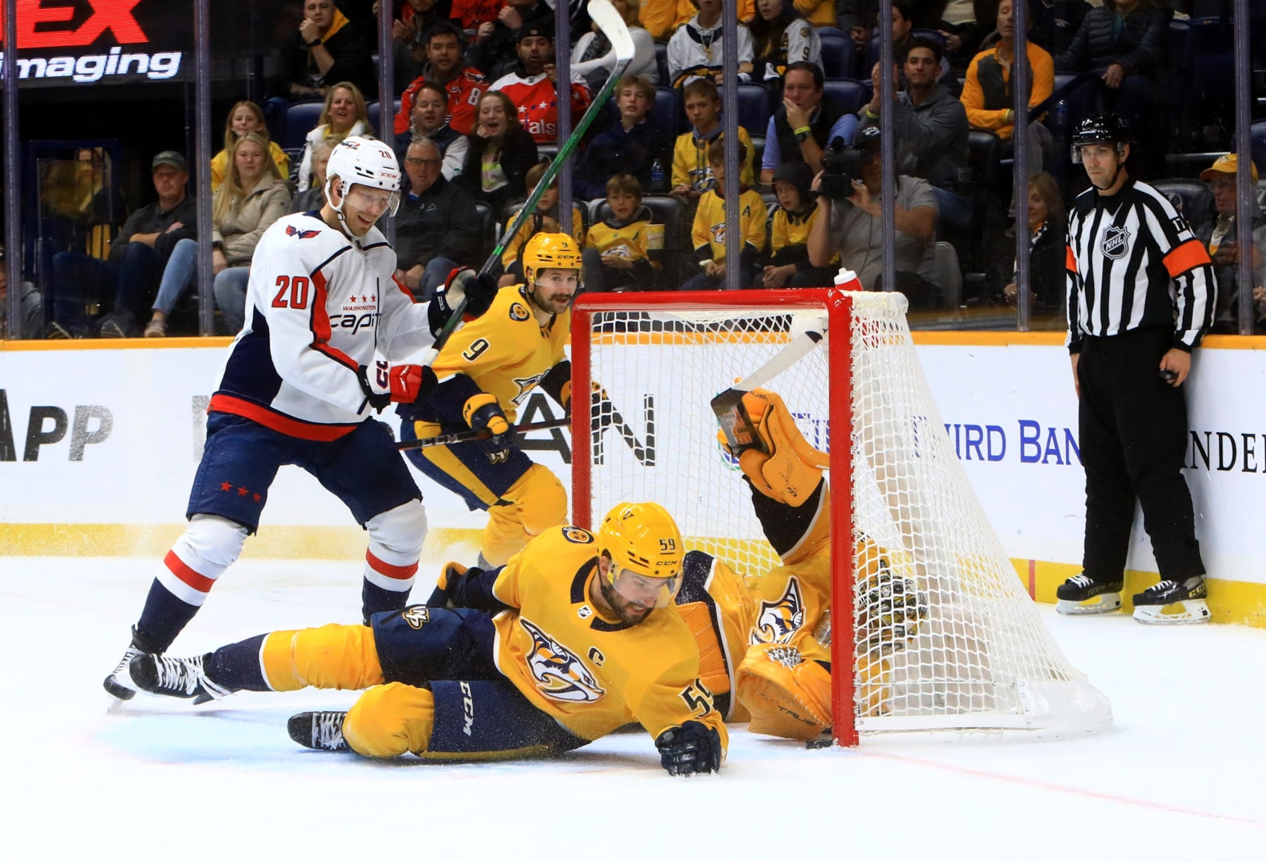 NASHVILLE, TN - OCTOBER 29: Washington Capitals center Lars Eller (20) and Nashville Predators left wing Filip Forsberg (9), of Sweden, look on as defenseman Roman Josi (59), of Switzerland, and goalie Juuse Saros (74), of Finland, keep the puck out of the net during the NHL game between the Nashville Predators and Washington Capitals, held on October 29, 2022, at Bridgestone Arena in Nashville, Tennessee. (Photo by Danny Murphy/Icon Sportswire via Getty Images) NASHVILLE, TN - OCTOBER 29: Washington Capitals center Lars Eller (20) and Nashville Predators left wing Filip Forsberg (9), of Sweden, look on as defenseman Roman Josi (59), of Switzerland, and goalie Juuse Saros (74), of Finland, keep the puck out of the net during the NHL game between the Nashville Predators and Washington Capitals, held on October 29, 2022, at Bridgestone Arena in Nashville, Tennessee. (Photo by Danny Murphy/Icon Sportswire via Getty Images)