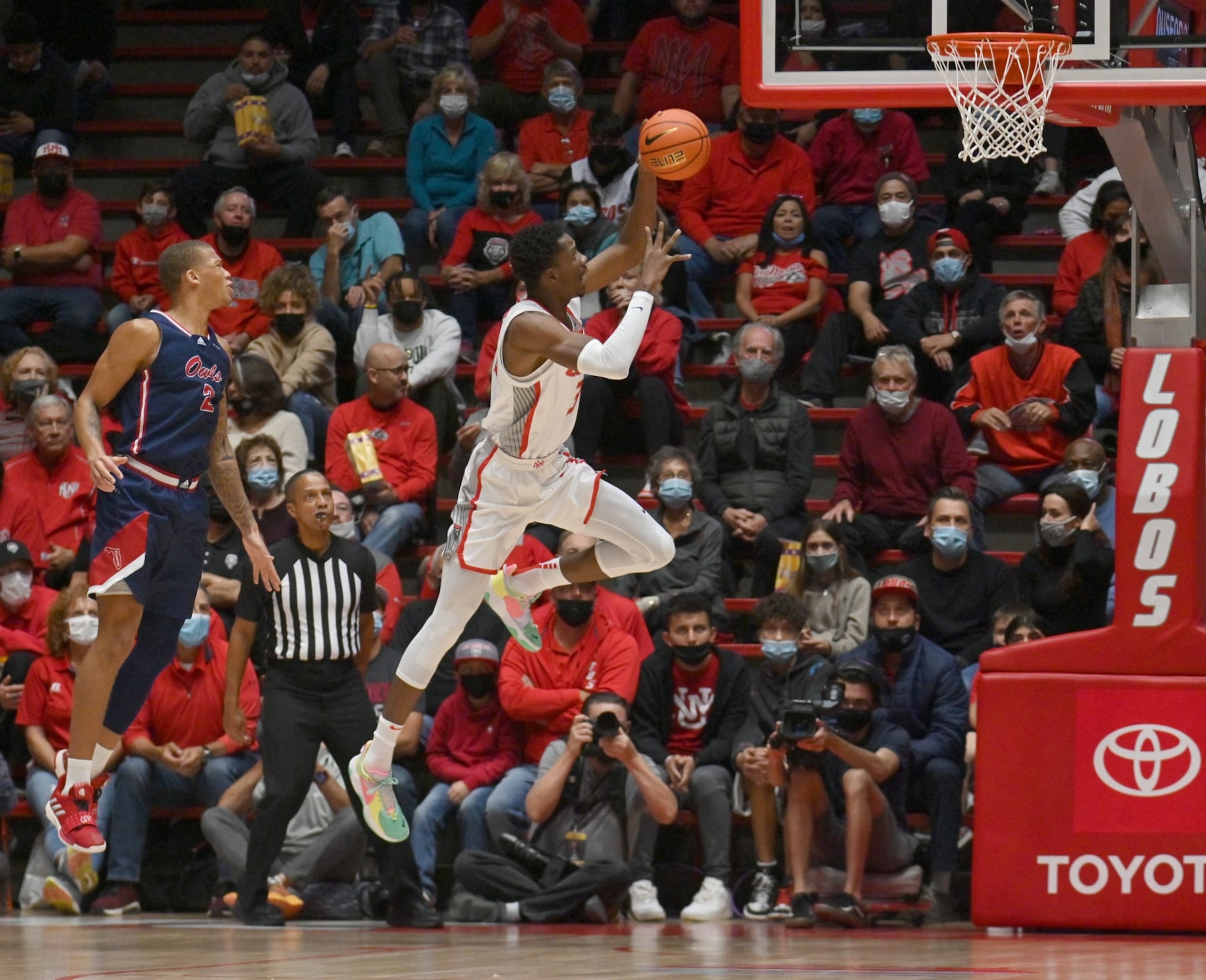 ALBUQUERQUE, NEW MEXICO - NOVEMBER 10: Gethro Muscadin #35 of the New Mexico Lobos drives to the basket past Everett Winchester #2 of the Florida Atlantic Owls at The Pit on November 10, 2021 in Albuquerque, New Mexico. (Photo by Sam Wasson/Getty Images) ALBUQUERQUE, NEW MEXICO - NOVEMBER 10: Gethro Muscadin #35 of the New Mexico Lobos drives to the basket past Everett Winchester #2 of the Florida Atlantic Owls at The Pit on November 10, 2021 in Albuquerque, New Mexico. (Photo by Sam Wasson/Getty Images)