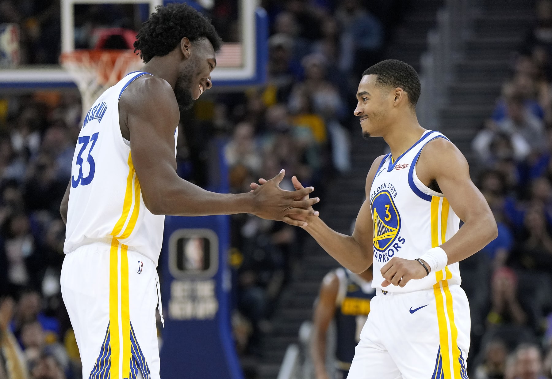 SAN FRANCISCO, CALIFORNIA - OCTOBER 14: James Wiseman #33 of the Golden State Warriors celebrates with Jordan Poole #3 after Wiseman scored against the Denver Nuggets during the first half of an NBA basketball game at Chase Center on October 14, 2022 in San Francisco, California. NOTE TO USER: User expressly acknowledges and agrees that, by downloading and or using this photograph, User is consenting to the terms and conditions of the Getty Images License Agreement. (Photo by Thearon W. Henderson/Getty Images)