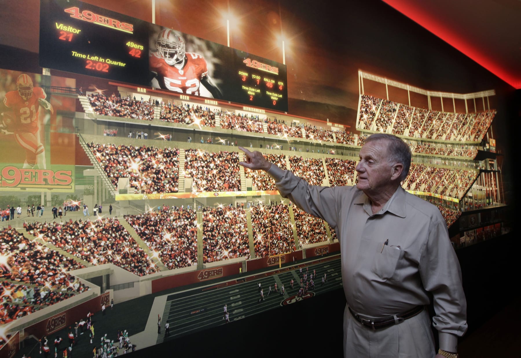 Retired San Francisco 49ers General Manager John McVay shows off where he would like to sit at the planned new home of the 49ers at the Preview Center in Santa Clara, Calif., Tuesday, Sept. 27, 2011. (AP Photo/Paul Sakuma)