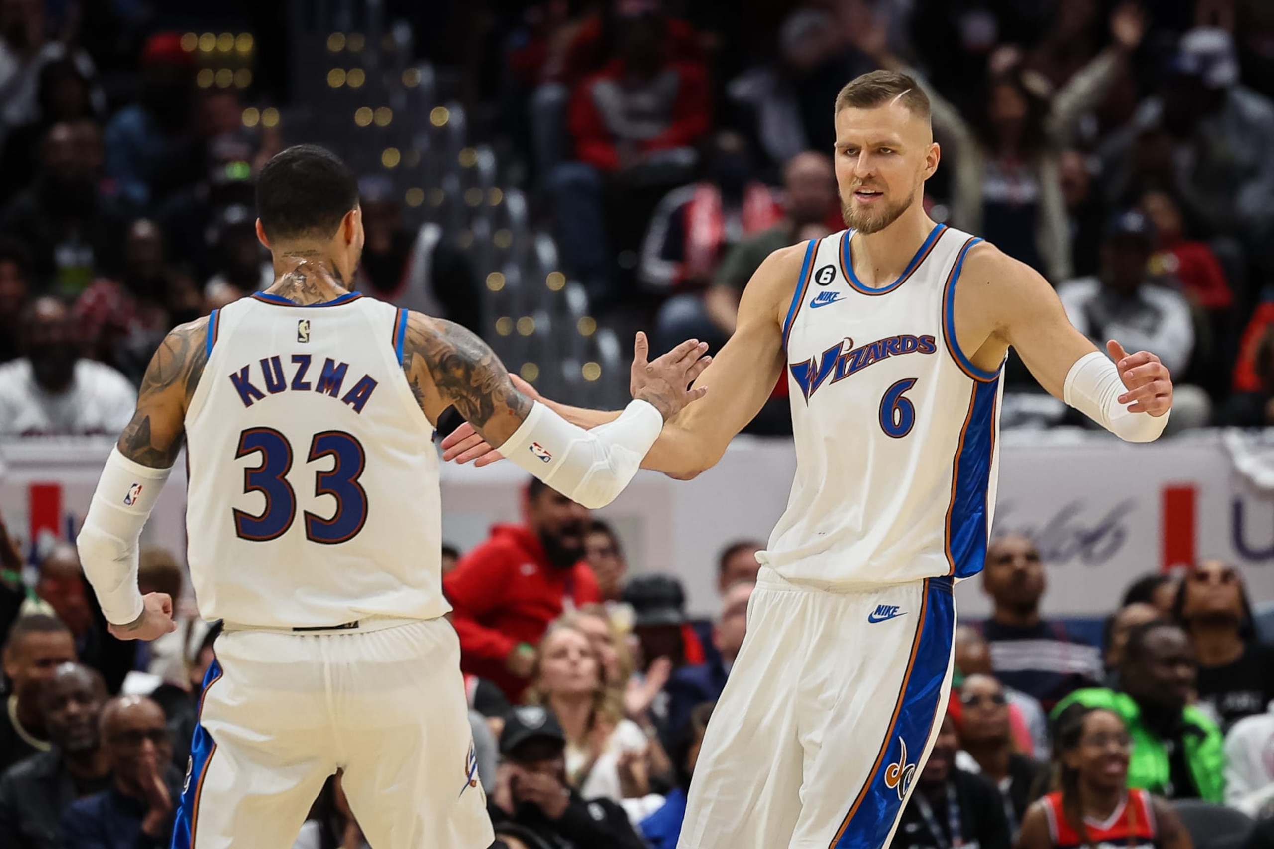 WASHINGTON, DC - OCTOBER 21: Kristaps Porzingis #6 of the Washington Wizards celebrates with Kyle Kuzma #33 after a play against the Chicago Bulls during the first half at Capital One Arena on October 21, 2022 in Washington, DC. NOTE TO USER: User expressly acknowledges and agrees that, by downloading and or using this photograph, User is consenting to the terms and conditions of the Getty Images License Agreement. (Photo by Scott Taetsch/Getty Images)