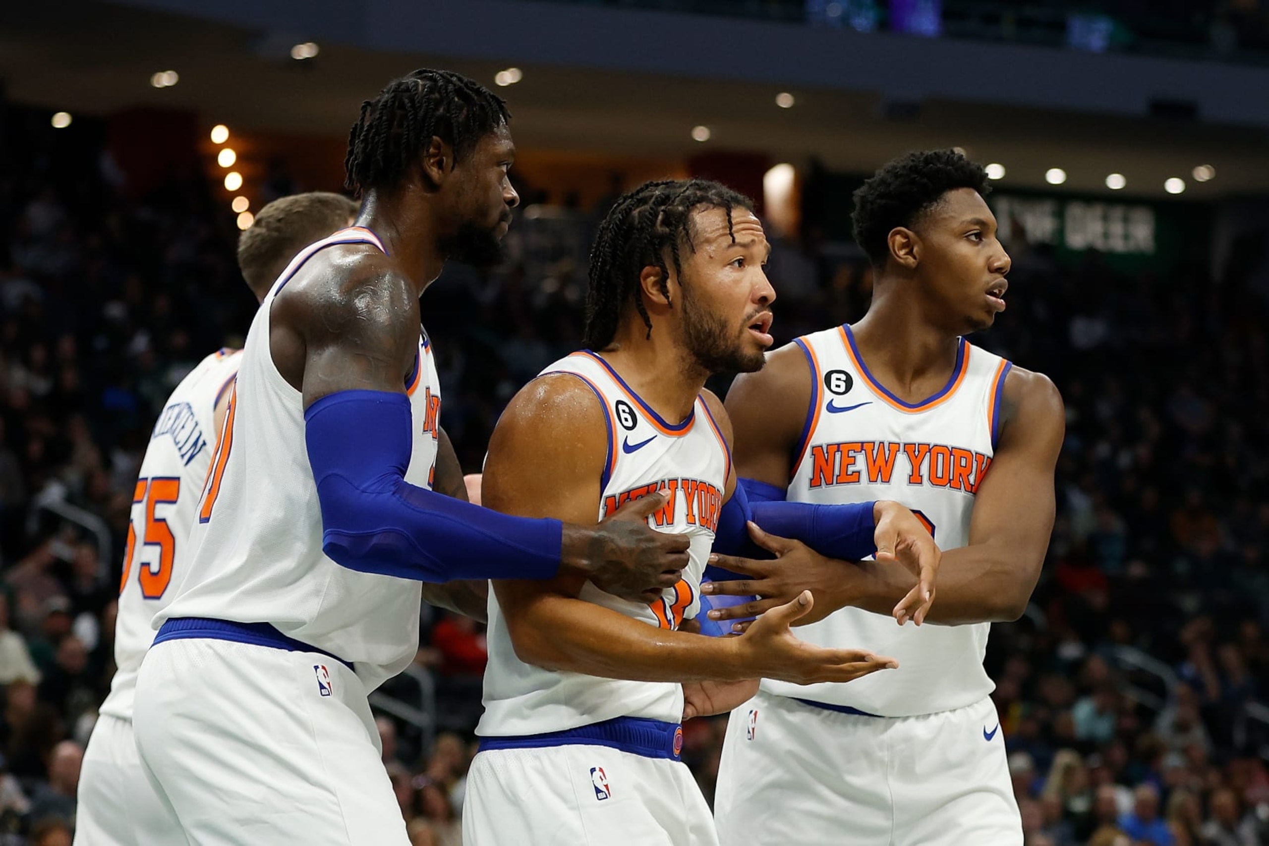 MILWAUKEE, WISCONSIN - OCTOBER 28: Jalen Brunson #11 of the New York Knicks is held back by Julius Randle #30 and RJ Barrett #9 of the New York Knicks after being called for a foul during the first half of the game at Fiserv Forum on October 28, 2022 in Milwaukee, Wisconsin. NOTE TO USER: User expressly acknowledges and agrees that, by downloading and or using this photograph, User is consenting to the terms and conditions of the Getty Images License Agreement. (Photo by John Fisher/Getty Images)