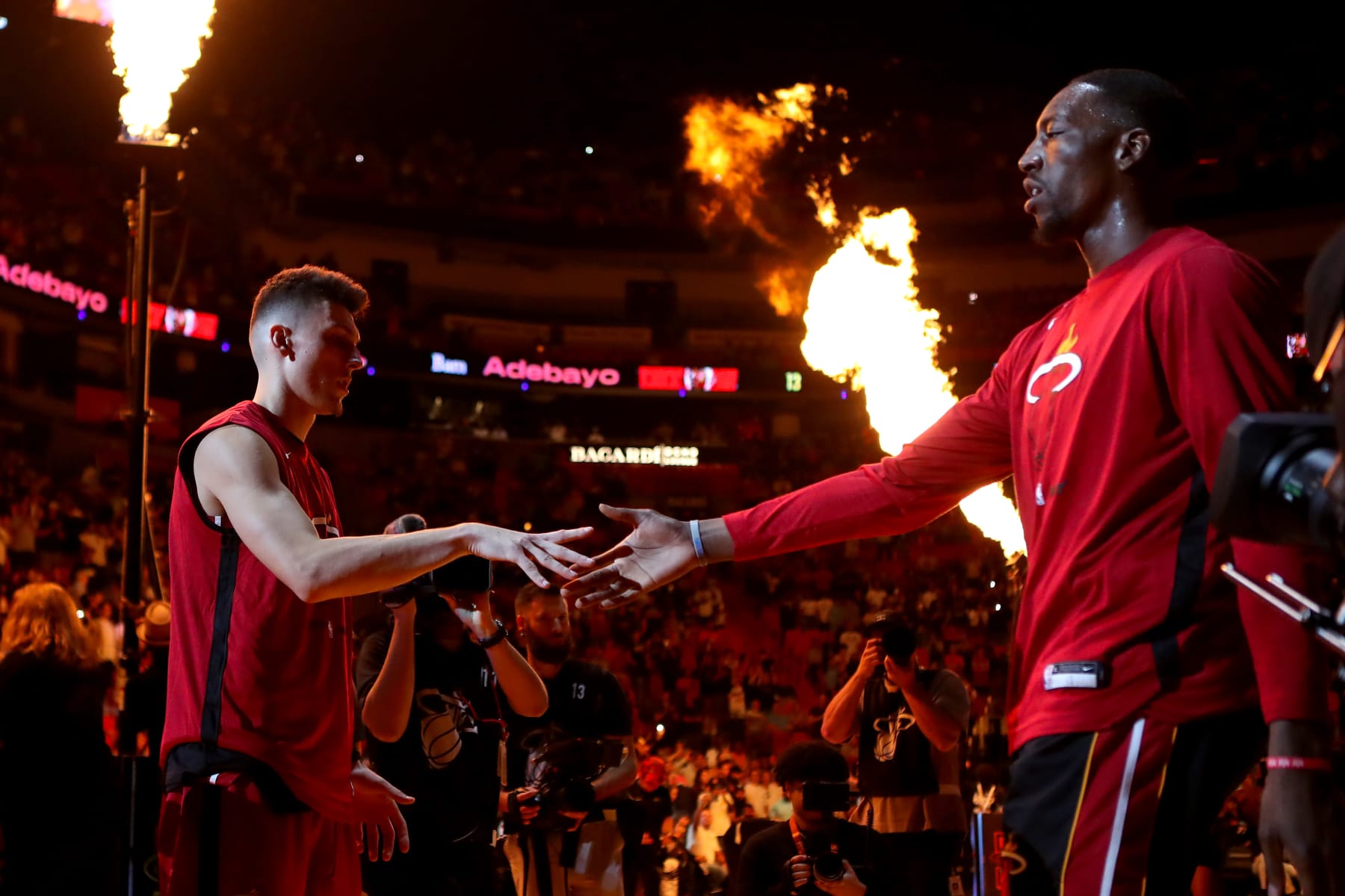 MIAMI, FLORIDA - OCTOBER 22: Bam Adebayo #13 of the Miami Heat high fives teammate Tyler Herro #14 after being introduced prior to playing against the Toronto Raptors at FTX Arena on October 22, 2022 in Miami, Florida. NOTE TO USER: User expressly acknowledges and agrees that, by downloading and or using this photograph, User is consenting to the terms and conditions of the Getty Images License Agreement. (Photo by Megan Briggs/Getty Images)