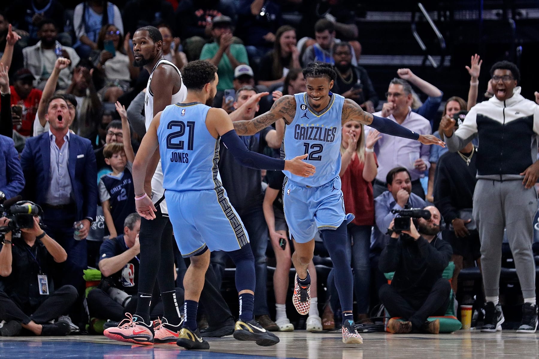 MEMPHIS, TENNESSEE - OCTOBER 24: Ja Morant #12 of the Memphis Grizzlies and Tyus Jones #21 celebrate during the game against the Brooklyn Nets at FedExForum on October 24, 2022 in Memphis, Tennessee. NOTE TO USER: User expressly acknowledges and agrees that, by downloading and or using this photograph, User is consenting to the terms and conditions of the Getty Images License Agreement. (Photo by Justin Ford/Getty Images)