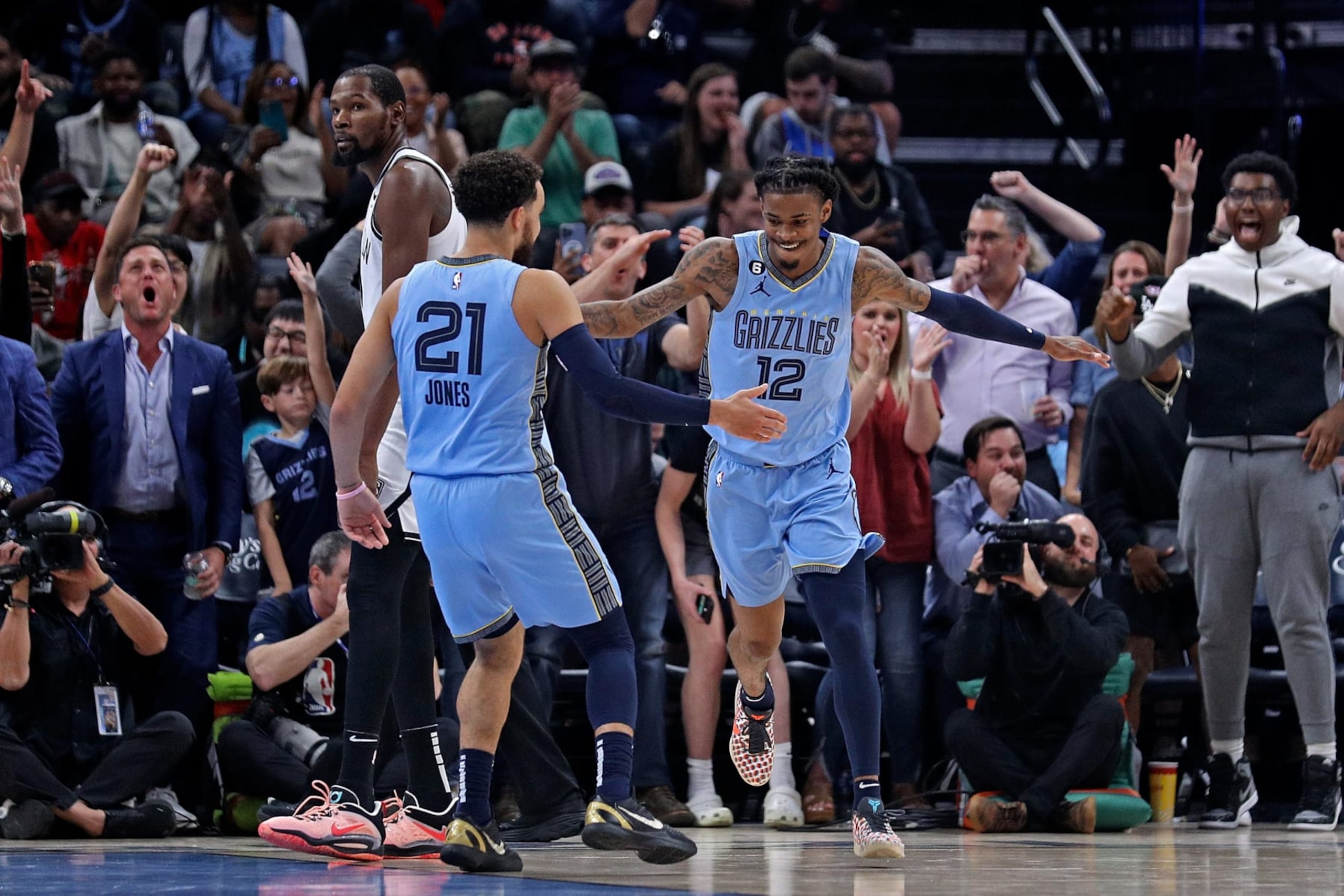 MEMPHIS, TENNESSEE - OCTOBER 24: Ja Morant #12 of the Memphis Grizzlies and Tyus Jones #21 celebrate during the game against the Brooklyn Nets at FedExForum on October 24, 2022 in Memphis, Tennessee. NOTE TO USER: User expressly acknowledges and agrees that, by downloading and or using this photograph, User is consenting to the terms and conditions of the Getty Images License Agreement. (Photo by Justin Ford/Getty Images)