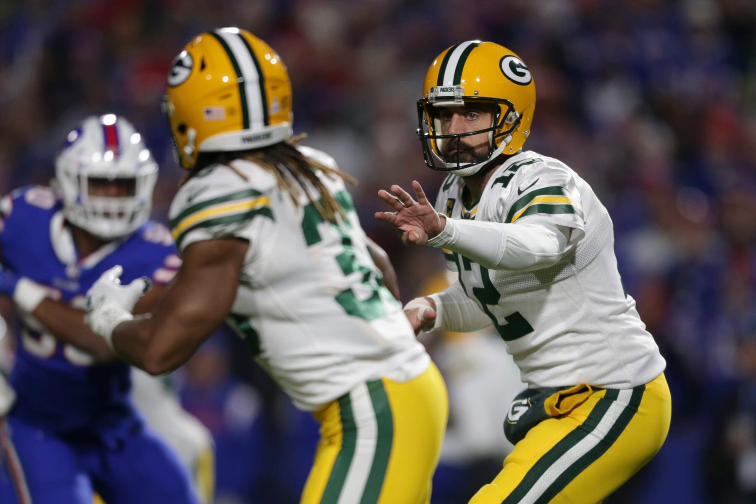 ORCHARD PARK, NEW YORK - OCTOBER 30: Aaron Rodgers #12 of the Green Bay Packers tosses the ball to Aaron Jones #33 during the first half at Highmark Stadium on October 30, 2022 in Orchard Park, New York. (Photo by Joshua Bessex/Getty Images) ORCHARD PARK, NEW YORK - OCTOBER 30: Aaron Rodgers #12 of the Green Bay Packers tosses the ball to Aaron Jones #33 during the first half at Highmark Stadium on October 30, 2022 in Orchard Park, New York. (Photo by Joshua Bessex/Getty Images)