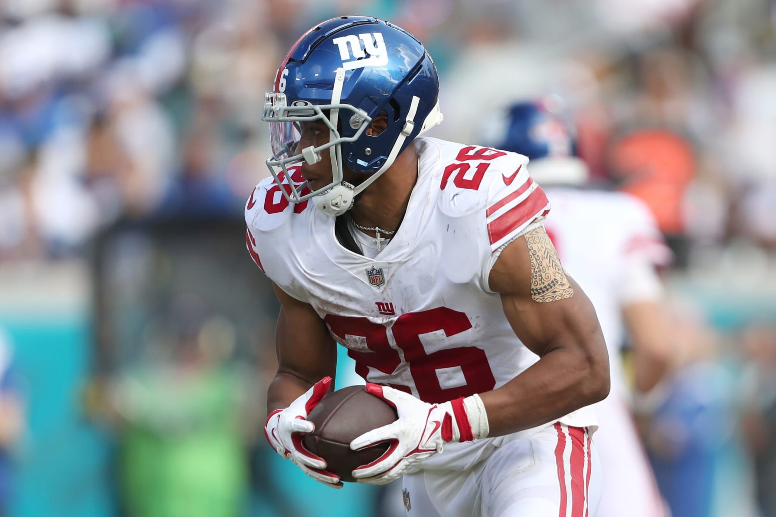 JACKSONVILLE, FLORIDA - OCTOBER 23: Saquon Barkley #26 of the New York Giants carries the ball during the second half against the Jacksonville Jaguars at TIAA Bank Field on October 23, 2022 in Jacksonville, Florida. (Photo by Courtney Culbreath/Getty Images)