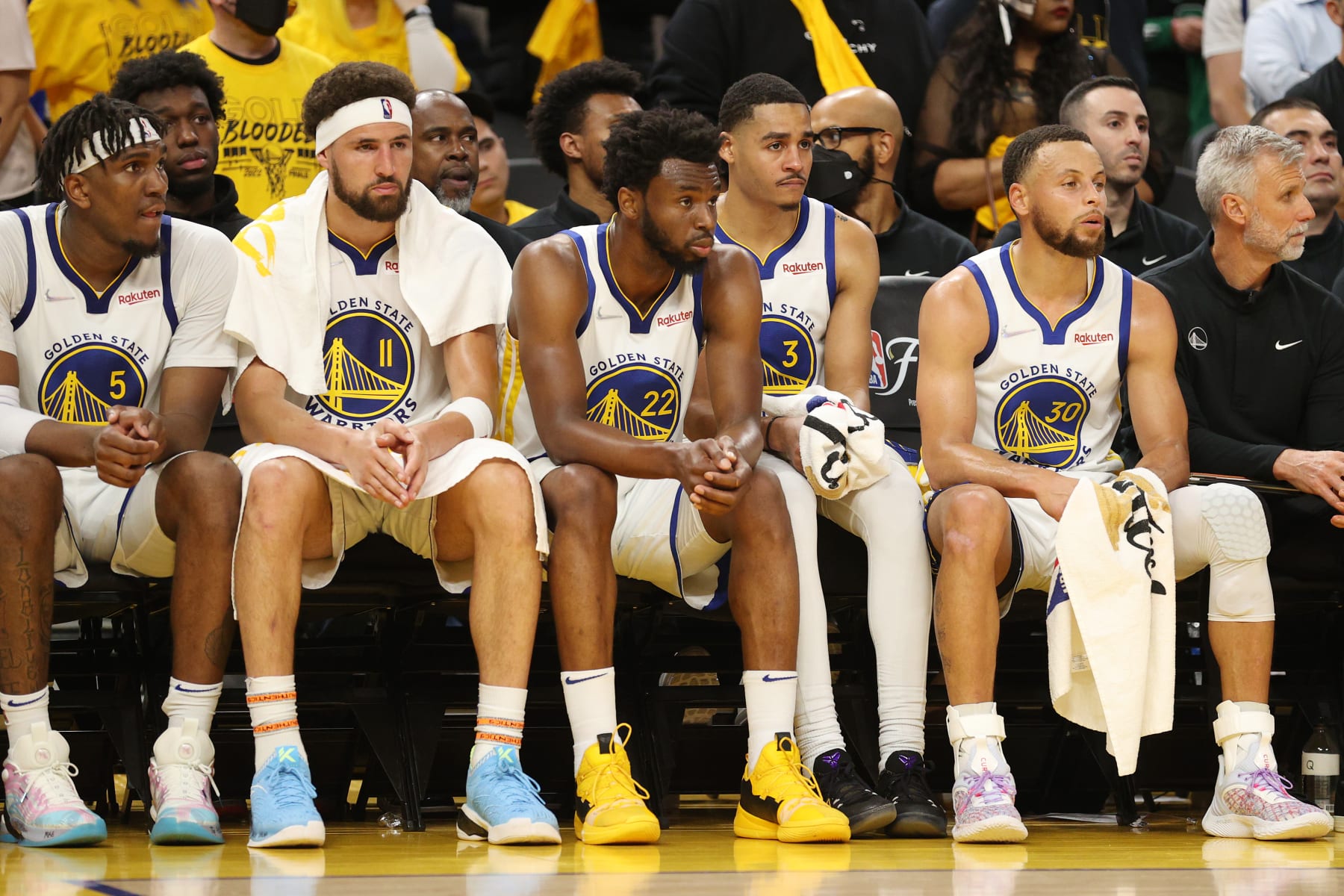 SAN FRANCISCO, CALIFORNIA - JUNE 02: (L to R) Kevon Looney #5, Klay Thompson #11, Andrew Wiggins #22, Jordan Poole #3, and Stephen Curry #30 of the Golden State Warriors look on from the bench during the fourth quarter against the Boston Celtics in Game One of the 2022 NBA Finals at Chase Center on June 02, 2022 in San Francisco, California. NOTE TO USER: User expressly acknowledges and agrees that, by downloading and/or using this photograph, User is consenting to the terms and conditions of the Getty Images License Agreement. (Photo by Ezra Shaw/Getty Images)