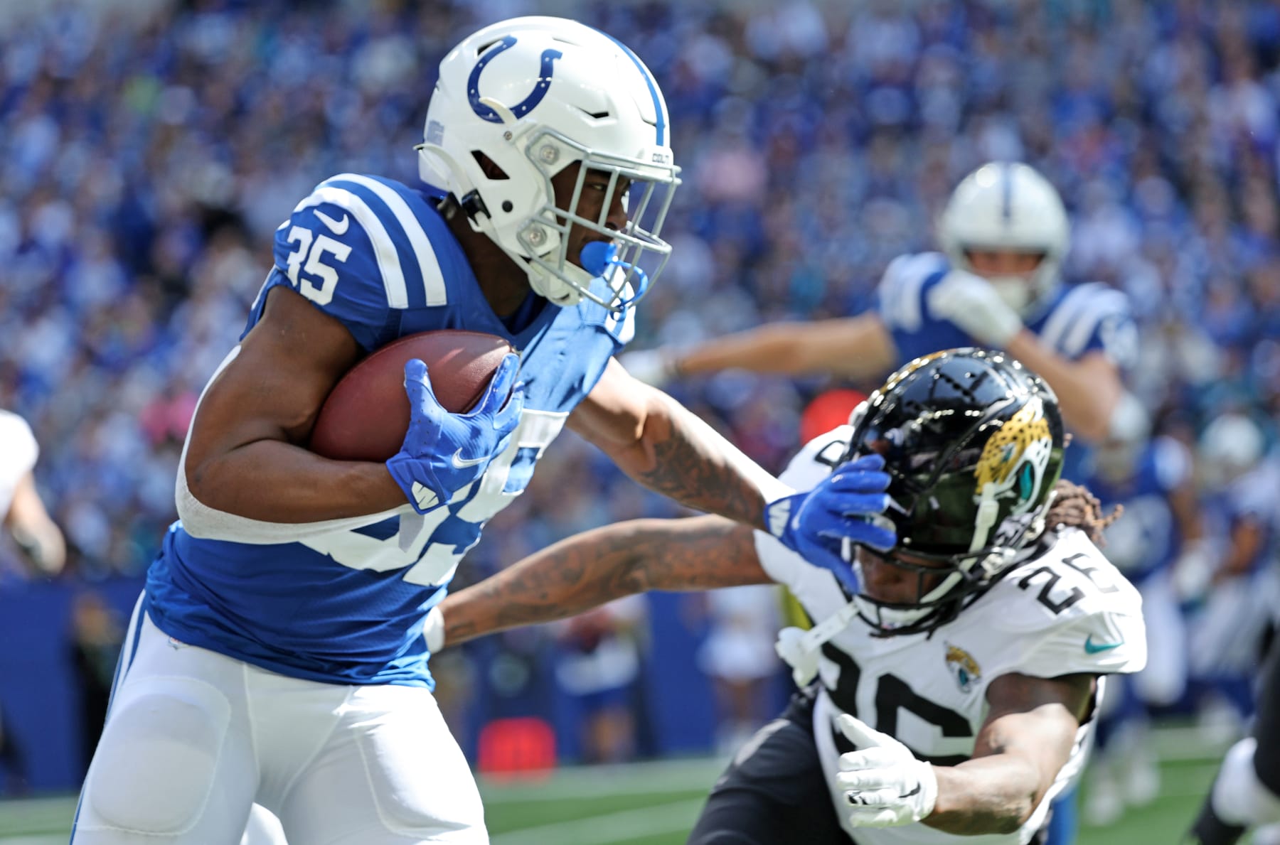 INDIANAPOLIS, INDIANA - OCTOBER 16: Deon Jackson #35 of the Indianapolis Colts runs against Shaquill Griffin #26 of the Jacksonville Jaguars during the first half at Lucas Oil Stadium on October 16, 2022 in Indianapolis, Indiana. (Photo by Michael Hickey/Getty Images)