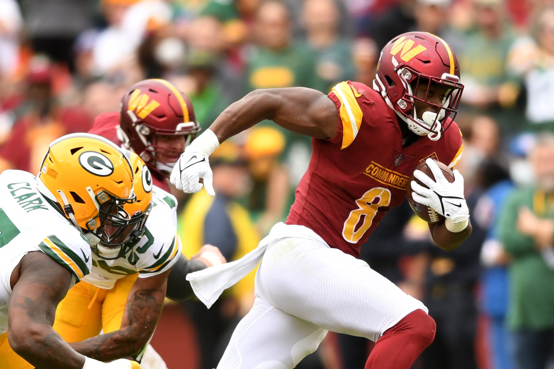 LANDOVER, MARYLAND - OCTOBER 23: Brian Robinson Jr. #8 of the Washington Commanders rushes forward during the first half of the game against the Green Bay Packers at FedExField on October 23, 2022 in Landover, Maryland. (Photo by Mitchell Layton/Getty Images)