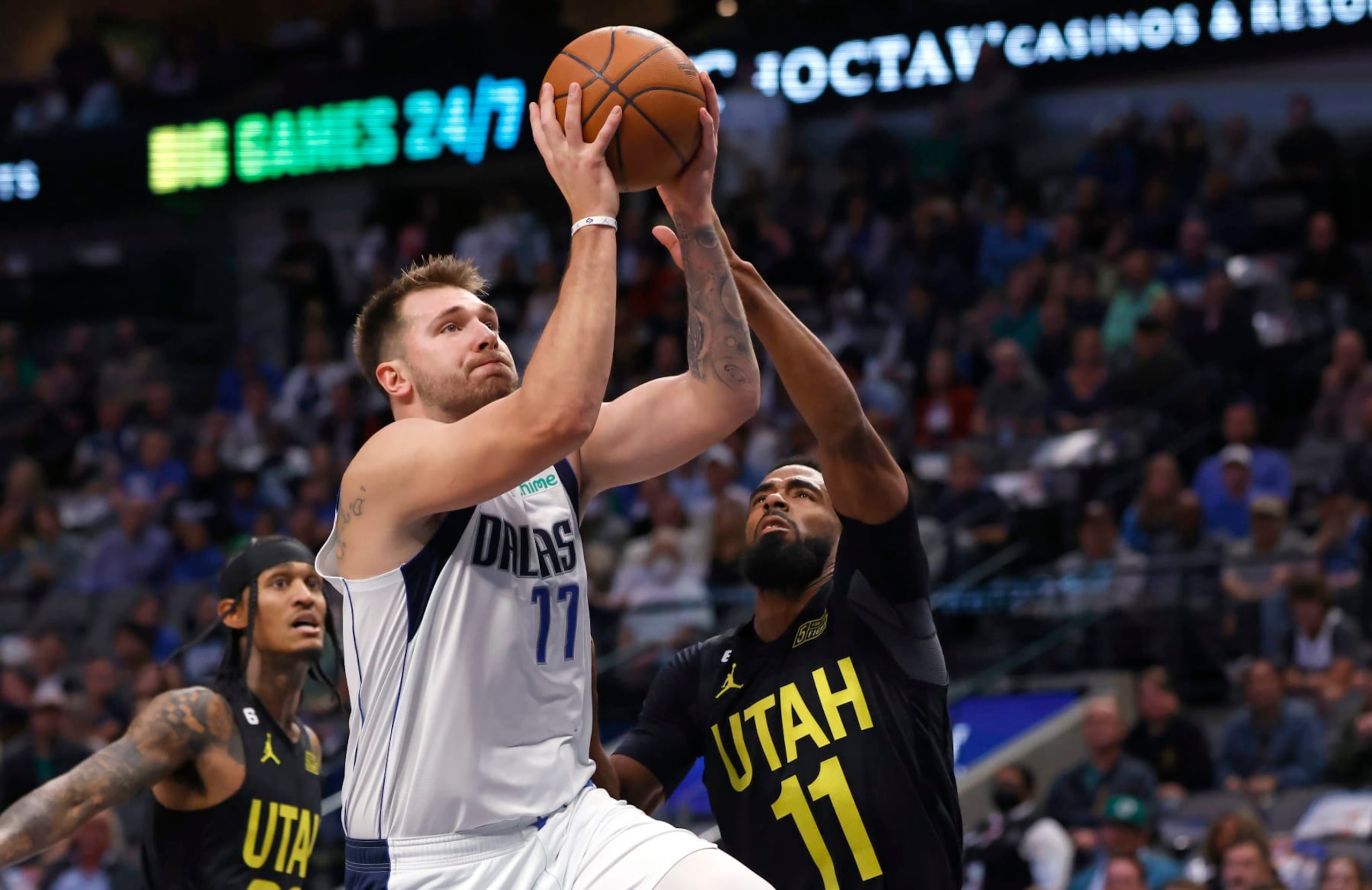 DALLAS, TX - NOVEMBER 2: Luka Doncic #77 of the Dallas Mavericks drives against Jordan Clarkson #00 and Mike Conley #11 of the Utah Jazz in the first half at American Airlines Center on November 2, 2022 in Dallas, Texas. NOTE TO USER: User expressly acknowledges and agrees that, by downloading and or using this photograph, User is consenting to the terms and conditions of the Getty Images License Agreement. (Photo by Ron Jenkins/Getty Images) DALLAS, TX - NOVEMBER 2: Luka Doncic #77 of the Dallas Mavericks drives against Jordan Clarkson #00 and Mike Conley #11 of the Utah Jazz in the first half at American Airlines Center on November 2, 2022 in Dallas, Texas. NOTE TO USER: User expressly acknowledges and agrees that, by downloading and or using this photograph, User is consenting to the terms and conditions of the Getty Images License Agreement. (Photo by Ron Jenkins/Getty Images)