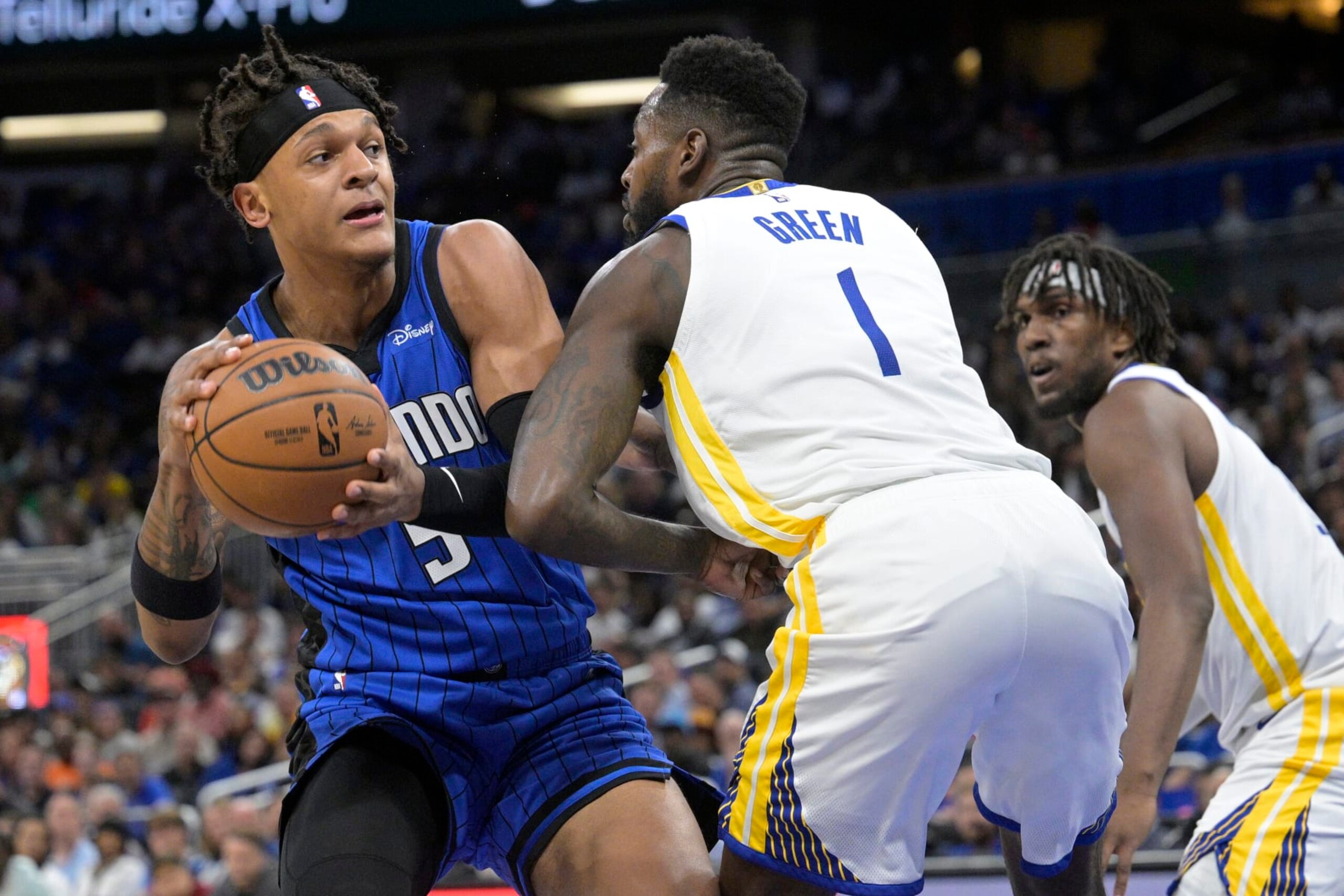 Orlando Magic forward Paolo Banchero (5) is defended by Golden State Warriors forward JaMychal Green (1) during the first half of an NBA basketball game Thursday, Nov. 3, 2022, in Orlando, Fla. (AP Photo/Phelan M. Ebenhack)