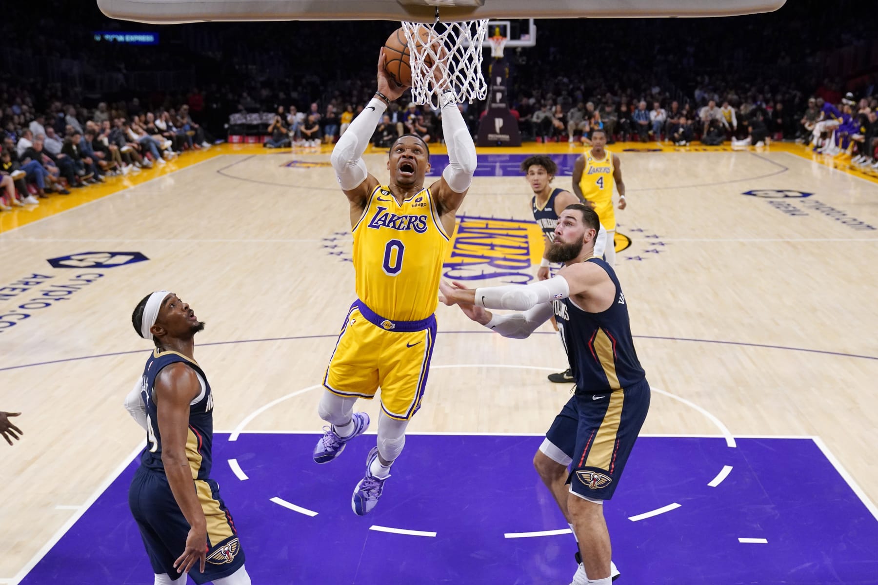 Los Angeles Lakers guard Russell Westbrook, center, shoots as New Orleans Pelicans guard Devonte' Graham, left, and center Jonas Valanciunas defend during the first half of an NBA basketball game Wednesday, Nov. 2, 2022, in Los Angeles. (AP Photo/Mark J. Terrill)