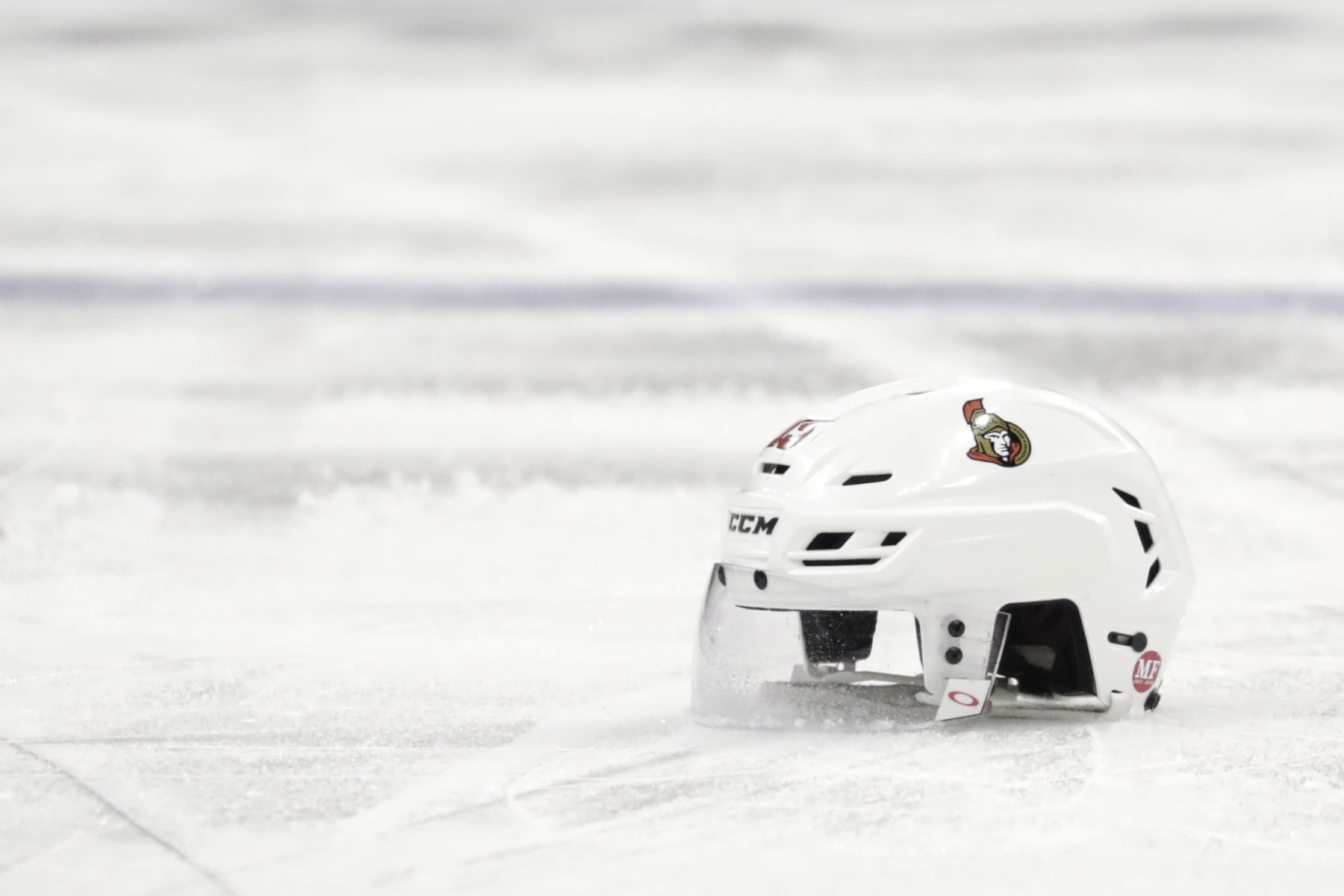 File-This Feb. 21, 2019, file photo shows the helmet belonging to Ottawa Senators left wing Zack Smith in the third period of an NHL hockey game against the New Jersey Devils, in Newark, N.J. The recent past, present and immediate future are all bleak for the Ottawa Senators. They’re on their way to missing the playoffs for the fourth time in six years, just sold off their top three forwards in trade-deadline fire sale and despite being dead-last in the NHL have no chance at a top-three pick in the draft because they included that in a deal last season. Gone in the past eight months are Erik Karlsson, Mike Hoffman, Mark Stone, Matt Duchene and Ryan Dzingel and what’s left is a void of uncertainty about just how long the Senators’ long-term rebuild will last. (AP Photo/Julio Cortez, File)