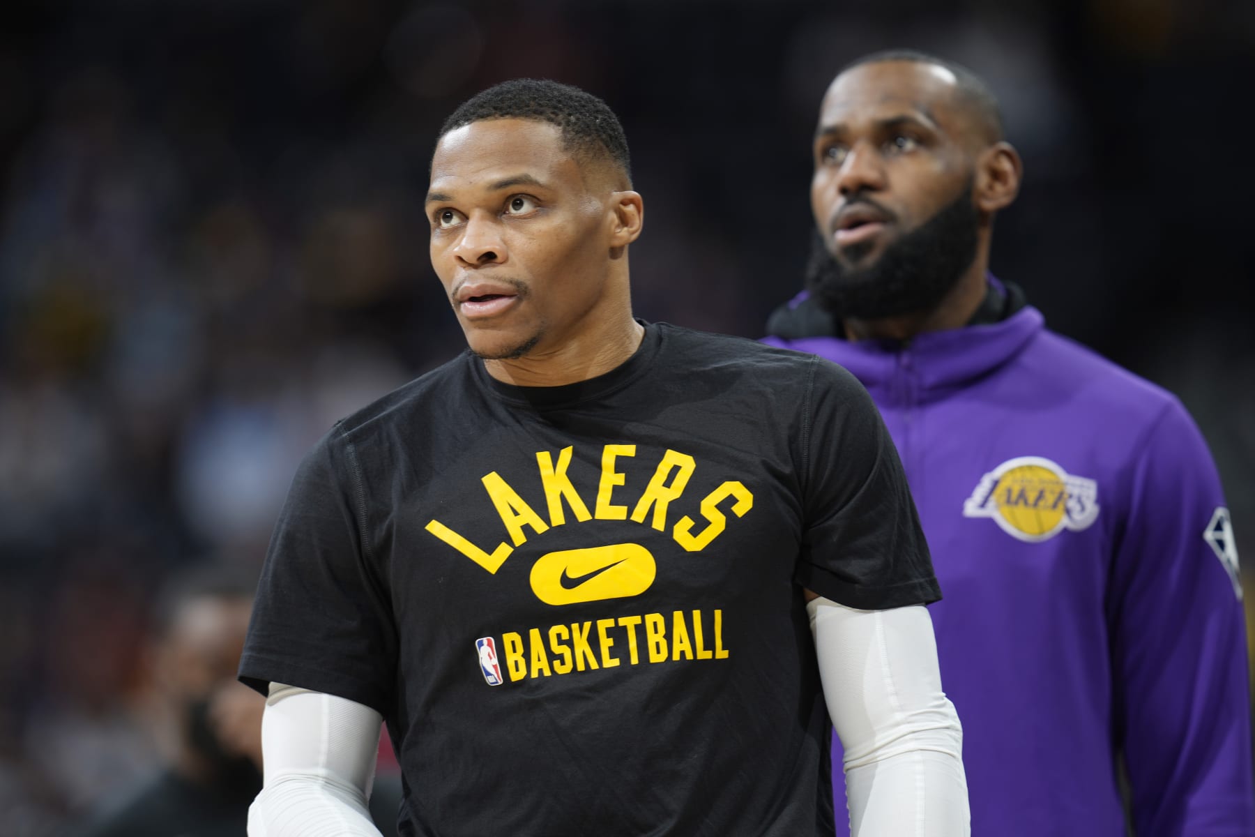 Los Angeles Lakers guard Russell Westbrook, front, warms up with forward LeBron James before the first half of an NBA basketball game against the Denver Nuggets Saturday Jan. 15, 2022, in Denver. (AP Photo/David Zalubowski)