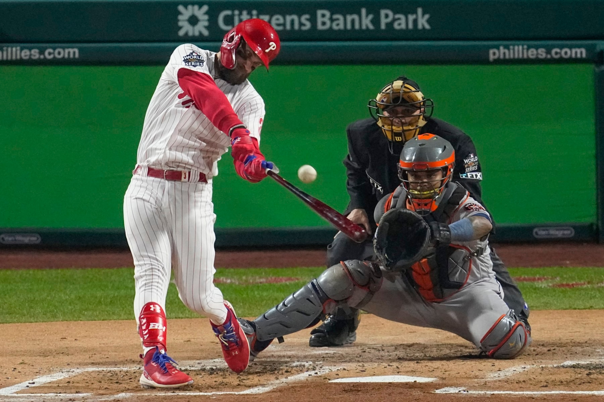 Philadelphia Phillies' Bryce Harper hits two-run home run during the first inning in Game 3 of baseball's World Series between the Houston Astros and the Philadelphia Phillies on Tuesday, Nov. 1, 2022, in Philadelphia. (AP Photo/Matt Rourke)