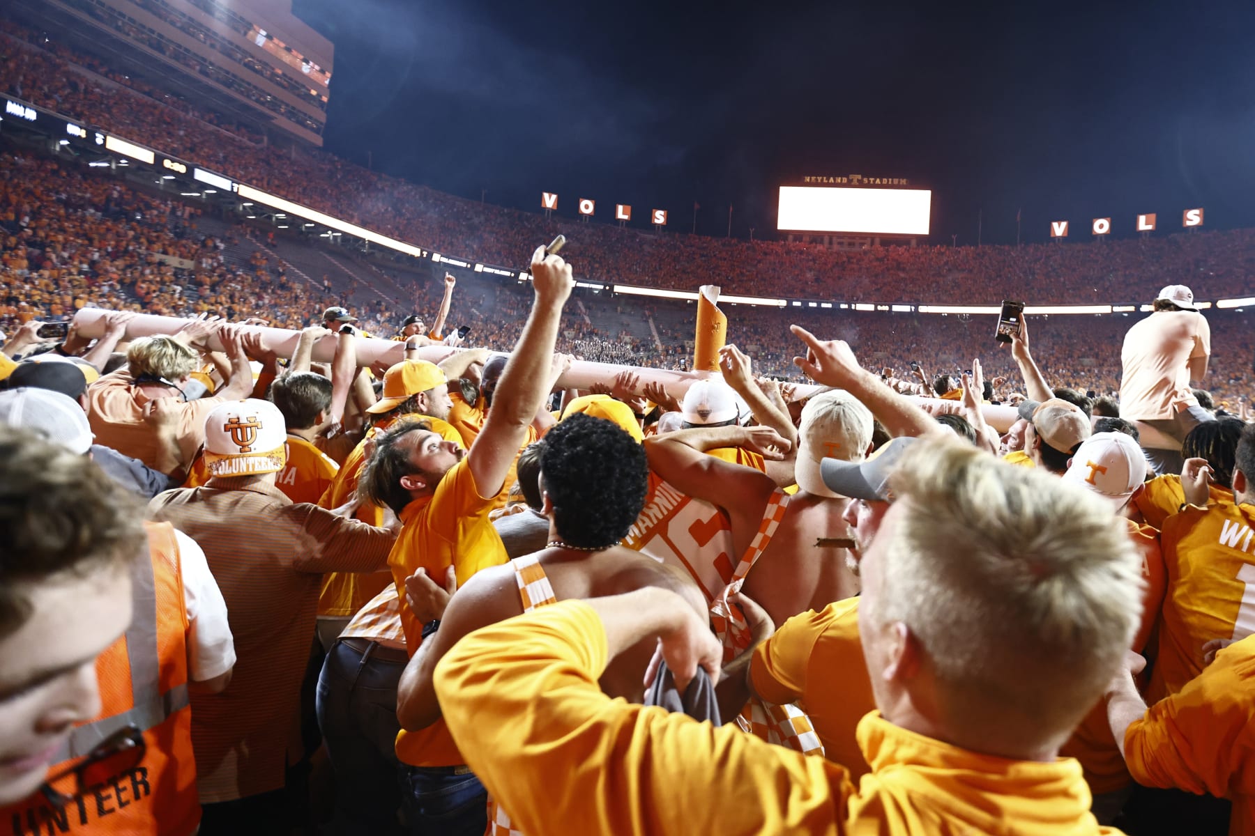 Fans carry a goal post as it was torn down after an NCAA college football game between Tennessee and Alabama Saturday, Oct. 15, 2022, in Knoxville, Tenn. Tennessee won 52-49. (AP Photo/Wade Payne)