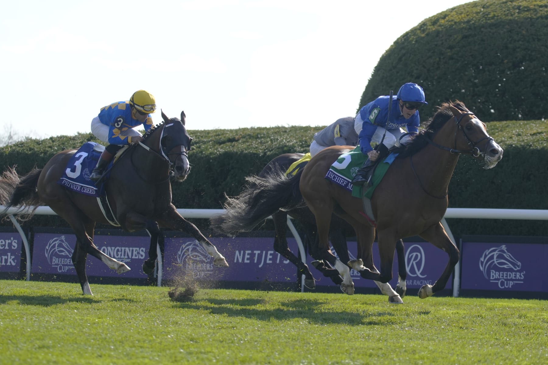 William Buick rides Mischief Magic (5) to victory past Ryan Moore on Dramatised (4) and Joel Rosario riding Private Creed (3) during the Breeders' Cup Juvenile Turf Sprint raceat the Keenelend Race Course, Friday, Nov. 4, 2022, in Lexington, Ky. (AP Photo/Jeff Roberson)
