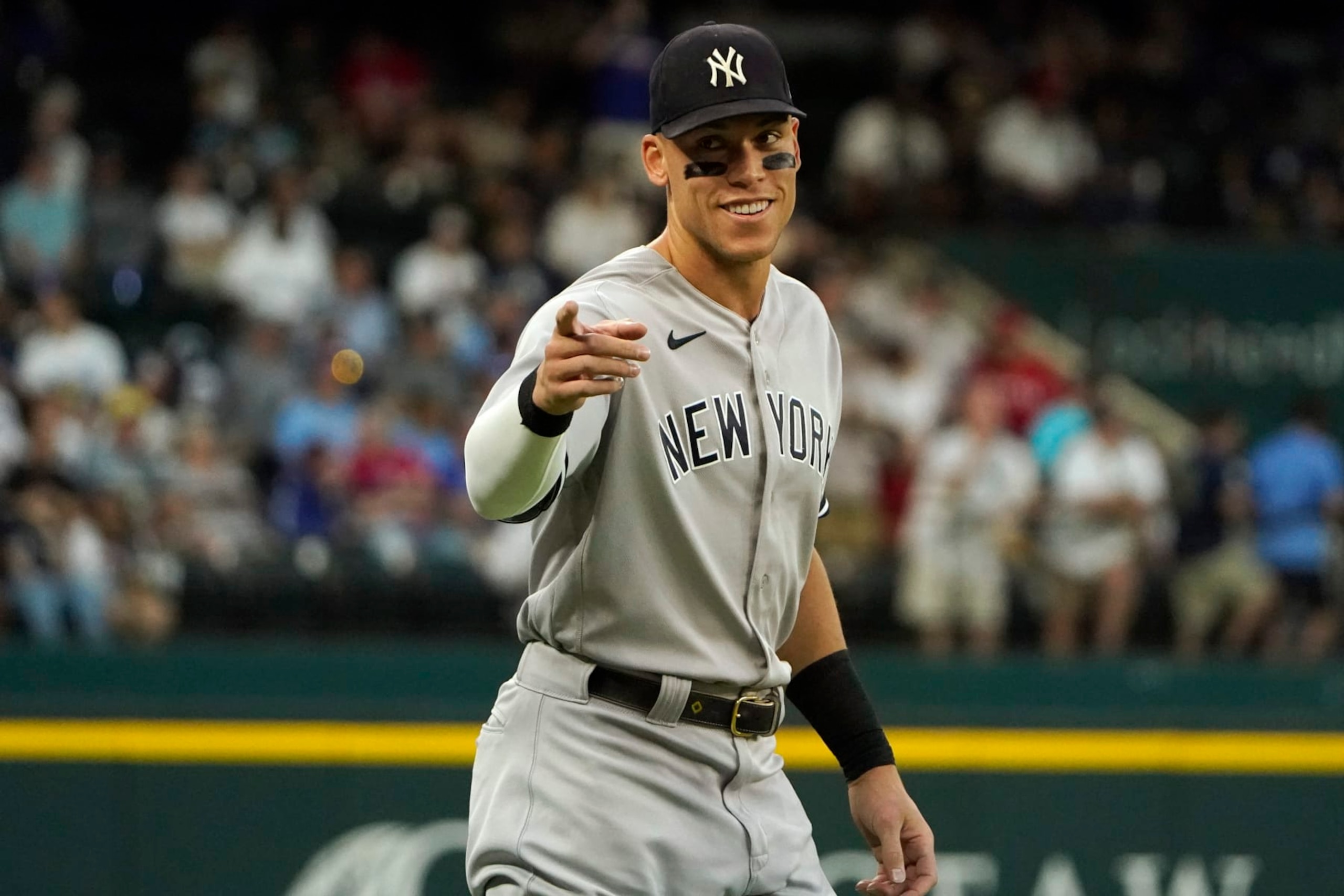New York Yankees' Aaron Judge points to fans during warm ups before the second baseball game of a doubleheader against the Texas Rangers in Arlington, Texas, Tuesday, Oct. 4, 2022. (AP Photo/LM Otero)