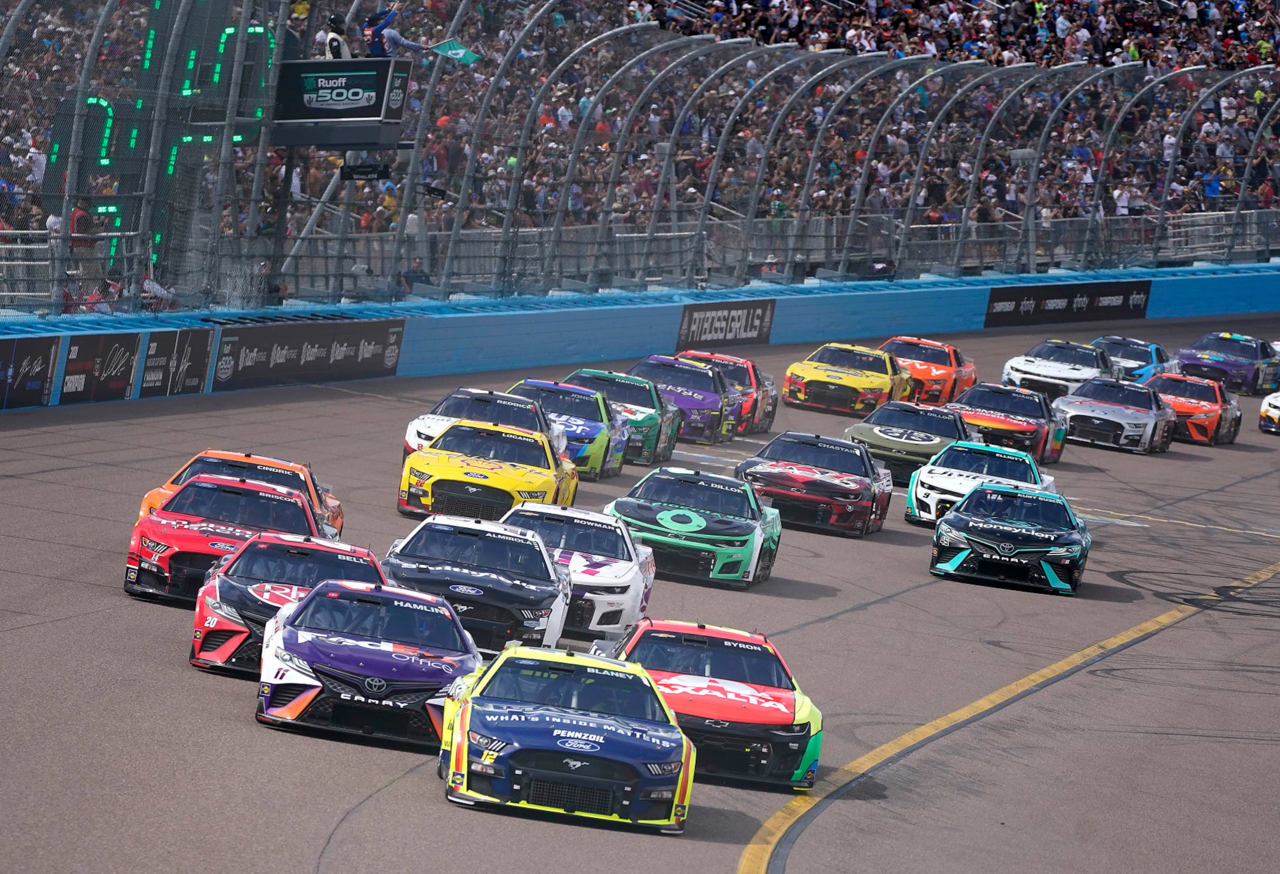 Cars take Turn 4 to start the first lap of a NASCAR Cup Series auto race at Phoenix Raceway, Sunday, March 13, 2022, in Avondale, Ariz. (AP Photo/Darryl Webb) Cars take Turn 4 to start the first lap of a NASCAR Cup Series auto race at Phoenix Raceway, Sunday, March 13, 2022, in Avondale, Ariz. (AP Photo/Darryl Webb)