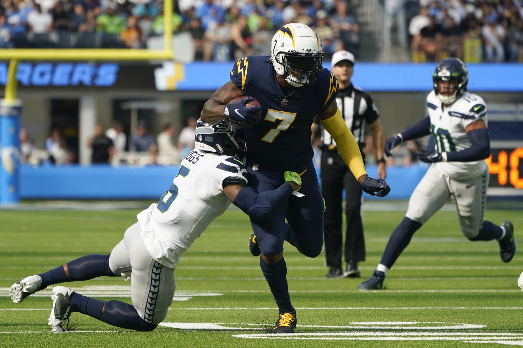 Los Angeles Chargers tight end Gerald Everett (7) is tackled by Seattle Seahawks safety Quandre Diggs (6) during the first half of an NFL football game Sunday, Oct. 23, 2022, in Inglewood, Calif. (AP Photo/Marcio Jose Sanchez)