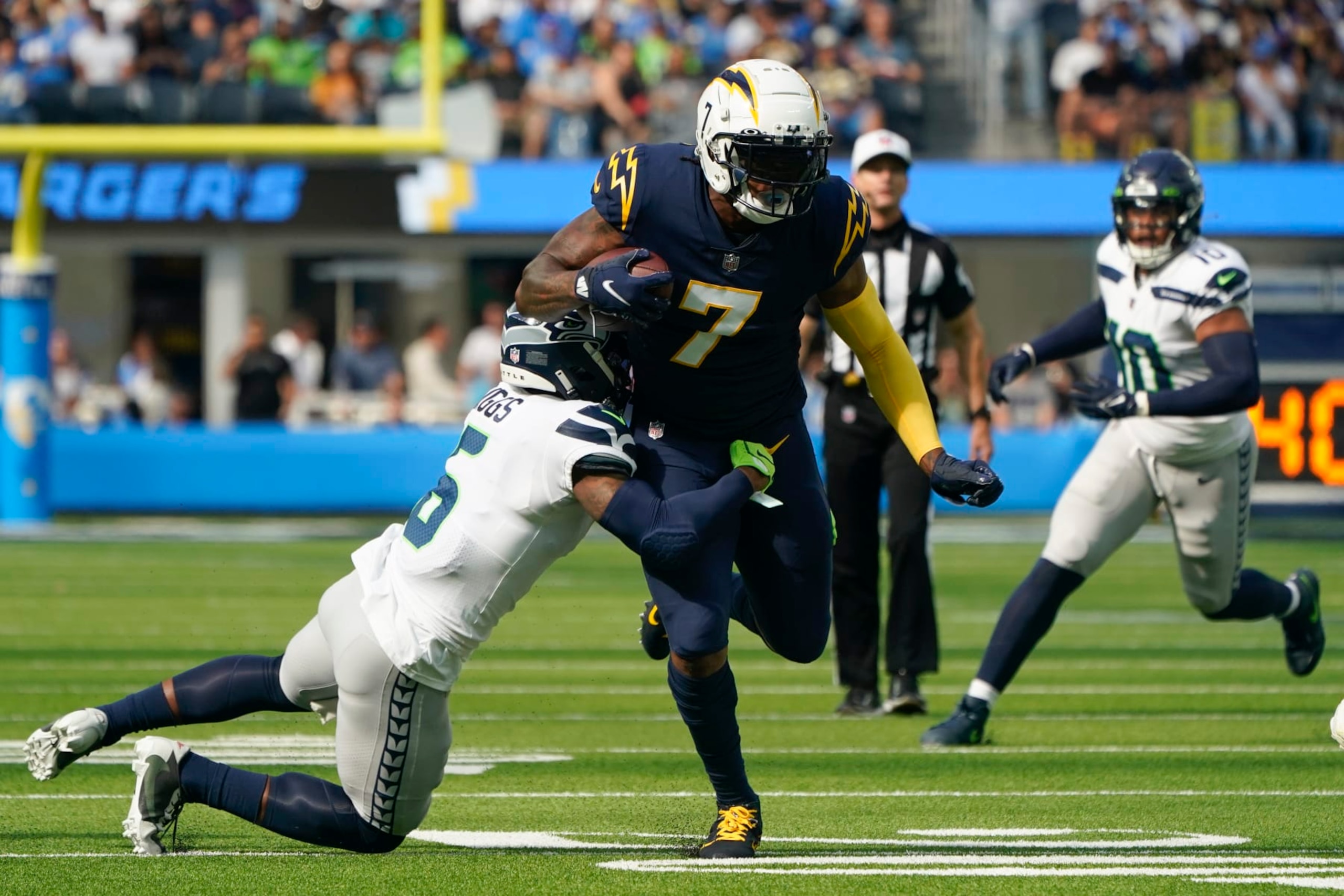 Los Angeles Chargers tight end Gerald Everett (7) is tackled by Seattle Seahawks safety Quandre Diggs (6) during the first half of an NFL football game Sunday, Oct. 23, 2022, in Inglewood, Calif. (AP Photo/Marcio Jose Sanchez) Los Angeles Chargers tight end Gerald Everett (7) is tackled by Seattle Seahawks safety Quandre Diggs (6) during the first half of an NFL football game Sunday, Oct. 23, 2022, in Inglewood, Calif. (AP Photo/Marcio Jose Sanchez)