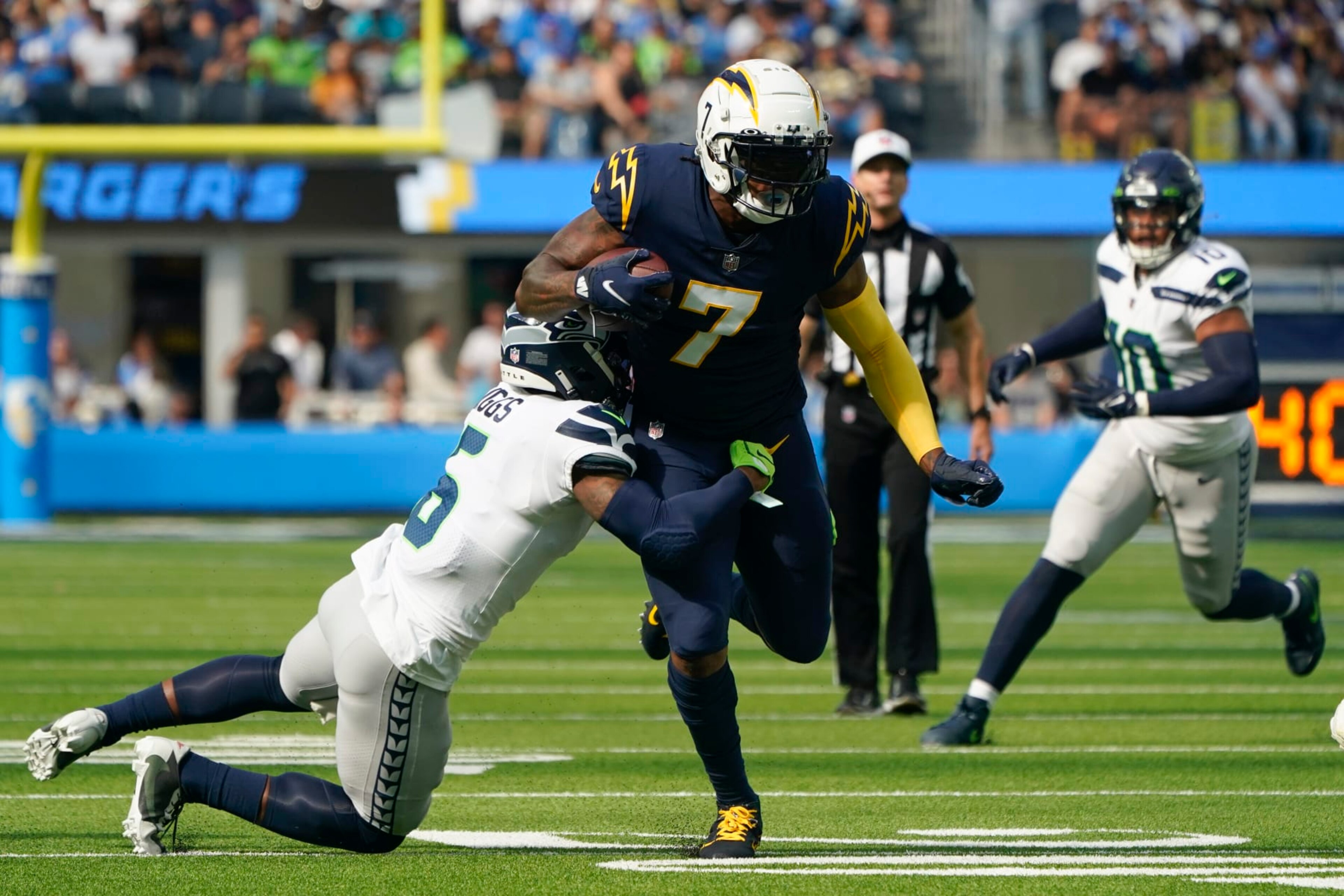 Los Angeles Chargers tight end Gerald Everett (7) is tackled by Seattle Seahawks safety Quandre Diggs (6) during the first half of an NFL football game Sunday, Oct. 23, 2022, in Inglewood, Calif. (AP Photo/Marcio Jose Sanchez)
