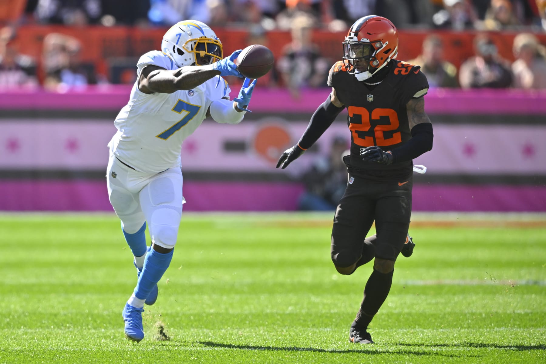 Los Angeles Chargers tight end Gerald Everett (7) can't quite make the catch as Cleveland Browns safety Grant Delpit (22) defends during the first half of an NFL football game, Sunday, Oct. 9, 2022, in Cleveland. (AP Photo/David Richard)