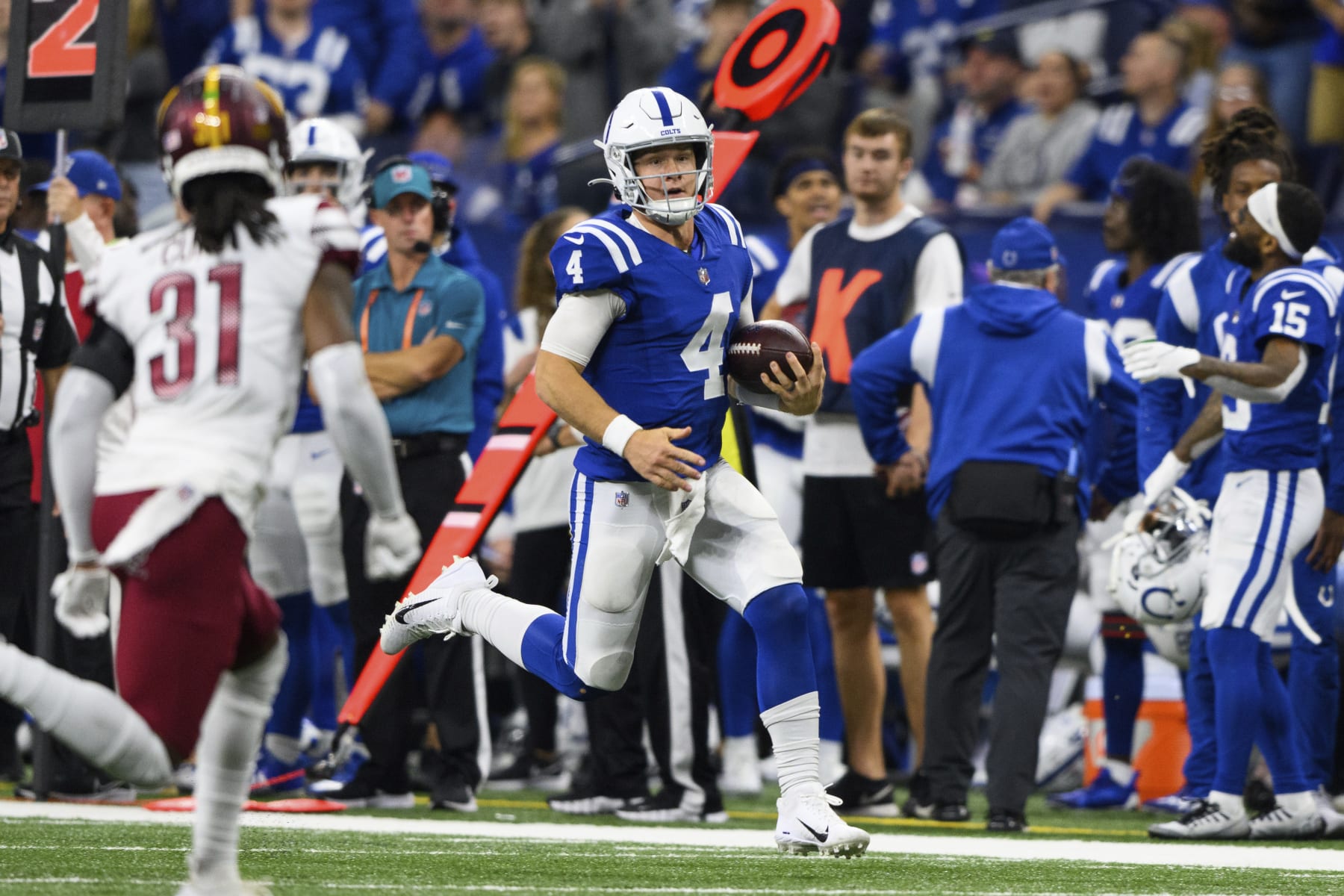 Indianapolis Colts quarterback Sam Ehlinger (4) runs down the sidelines during an NFL football game against the Washington Commanders, Sunday, Oct. 30, 2022, in Indianapolis. (AP Photo/Zach Bolinger)