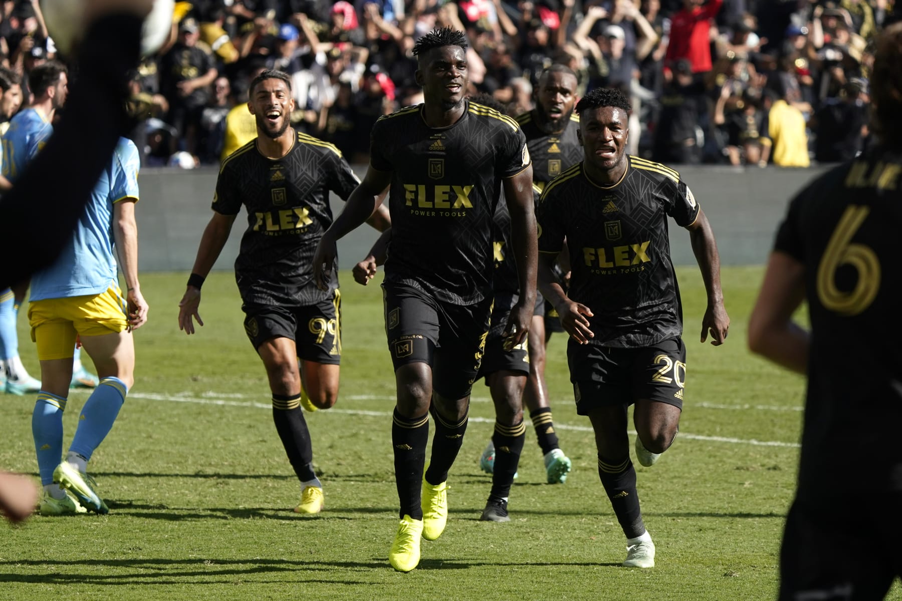 Los Angeles FC defender Jesús Murillo (3), middle, celebrates after scoring a goal in the second half during the MLS Cup soccer match against the Philadelphia Union, Saturday, Nov. 5, 2022, in Los Angeles. (AP Photo/Marcio Jose Sanchez)