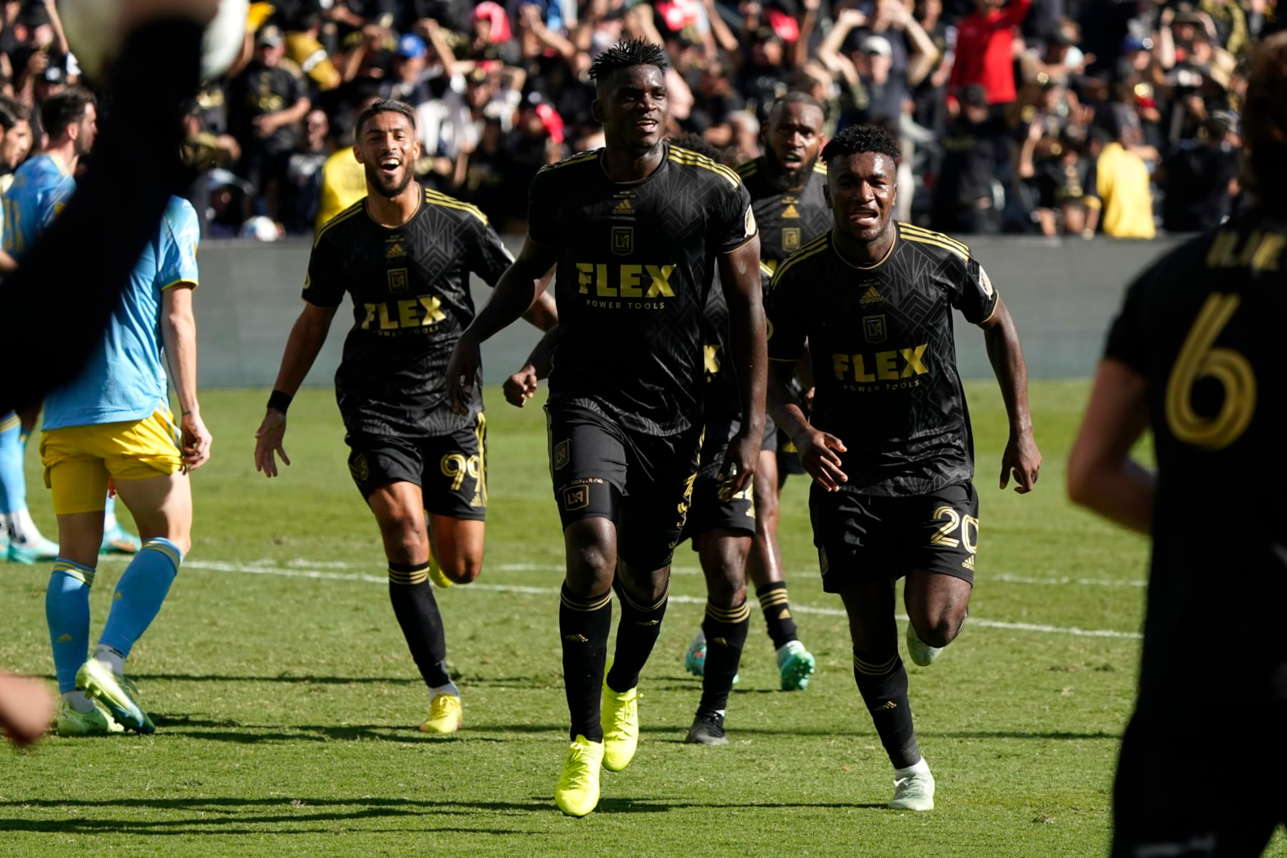 Los Angeles FC defender Jesús Murillo (3), middle, celebrates after scoring a goal in the second half during the MLS Cup soccer match against the Philadelphia Union, Saturday, Nov. 5, 2022, in Los Angeles. (AP Photo/Marcio Jose Sanchez)