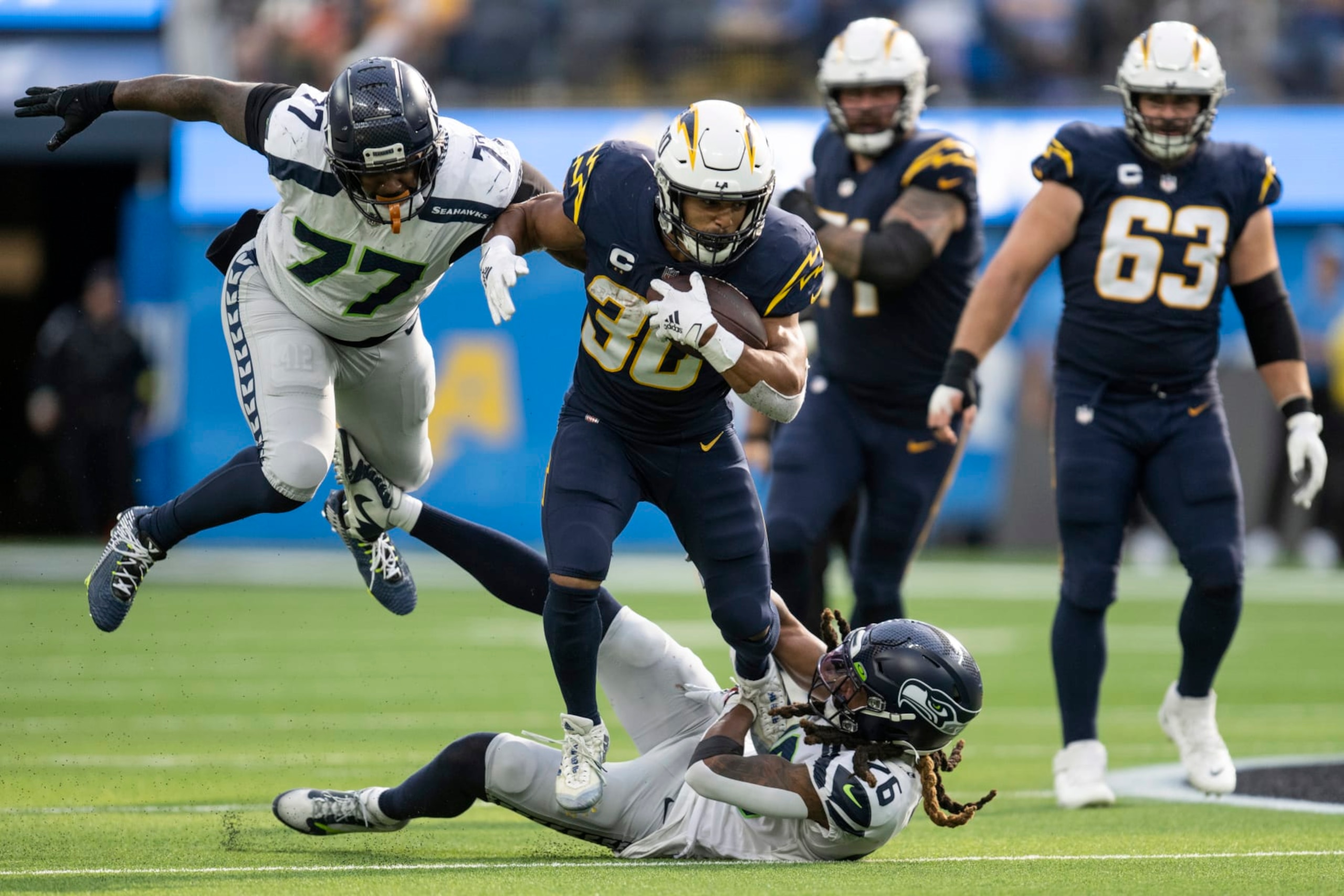 Seattle Seahawks defensive tackle Quinton Jefferson (77) and safety Ryan Neal (26) tackle Los Angeles Chargers running back Austin Ekeler (30) during an NFL football game, Sunday, Oct. 23, 2022, in Inglewood, Calif. (AP Photo/Kyusung Gong) Seattle Seahawks defensive tackle Quinton Jefferson (77) and safety Ryan Neal (26) tackle Los Angeles Chargers running back Austin Ekeler (30) during an NFL football game, Sunday, Oct. 23, 2022, in Inglewood, Calif. (AP Photo/Kyusung Gong)