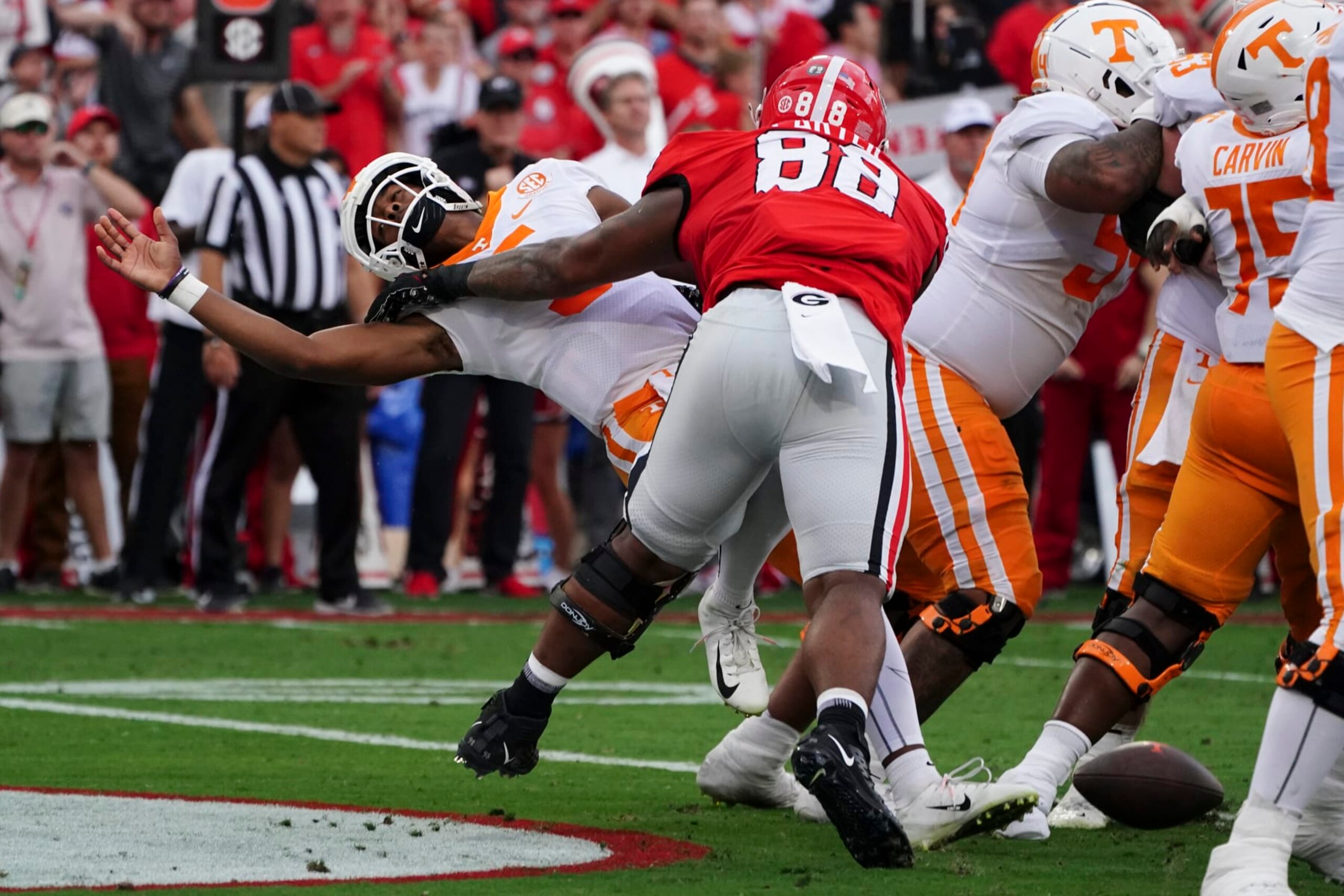 Tennessee quarterback Hendon Hooker, left, fumbles as he is hit by Georgia defensive lineman Jalen Carter (88) in the end zone during the first half of an NCAA college football game Saturday, Nov. 5, 2022, in Athens, Ga. Tennessee recovered the ball and avoided a safety. (AP Photo/John Bazemore) Tennessee quarterback Hendon Hooker, left, fumbles as he is hit by Georgia defensive lineman Jalen Carter (88) in the end zone during the first half of an NCAA college football game Saturday, Nov. 5, 2022, in Athens, Ga. Tennessee recovered the ball and avoided a safety. (AP Photo/John Bazemore)